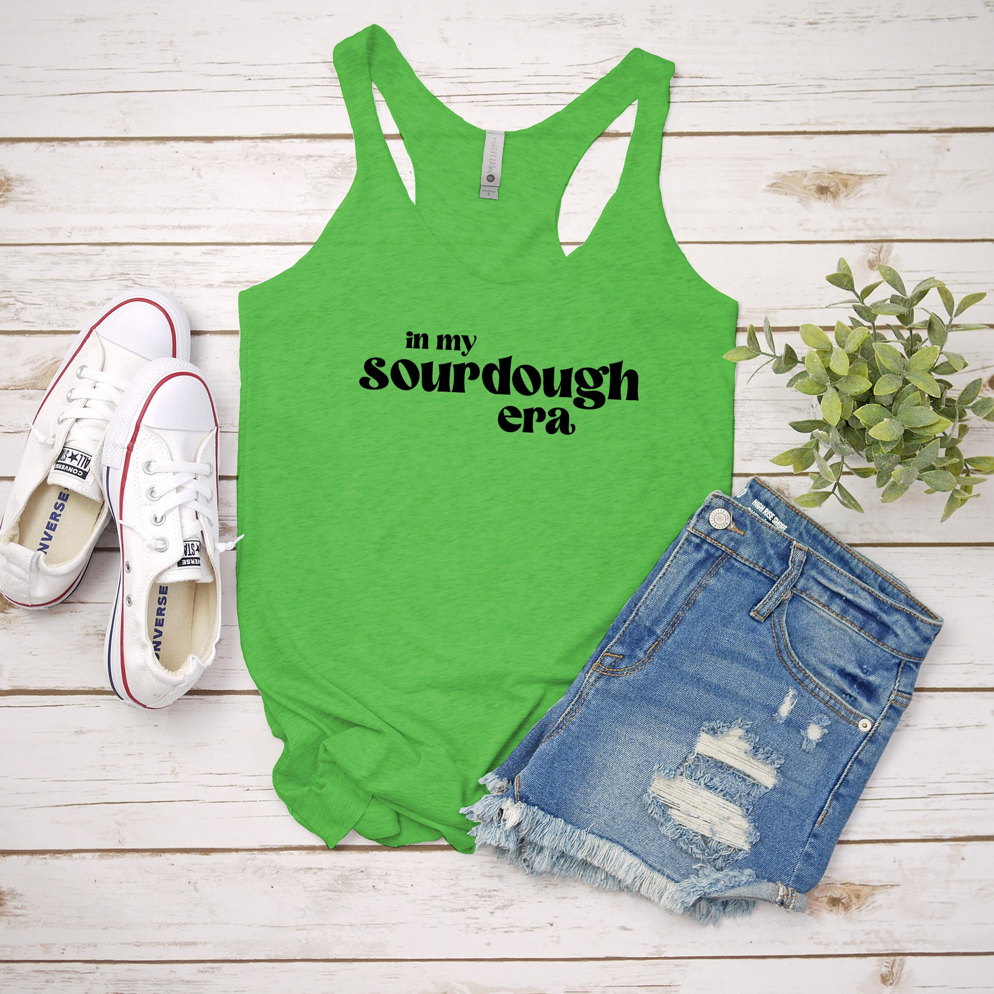 a green tank top that says, in my sourdough era