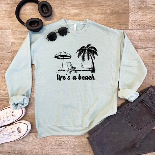 a sweatshirt that says life's a beach next to a pair of headphones