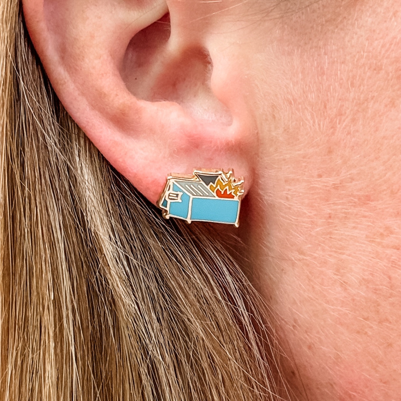 a close up of a person wearing a pair of ear clips