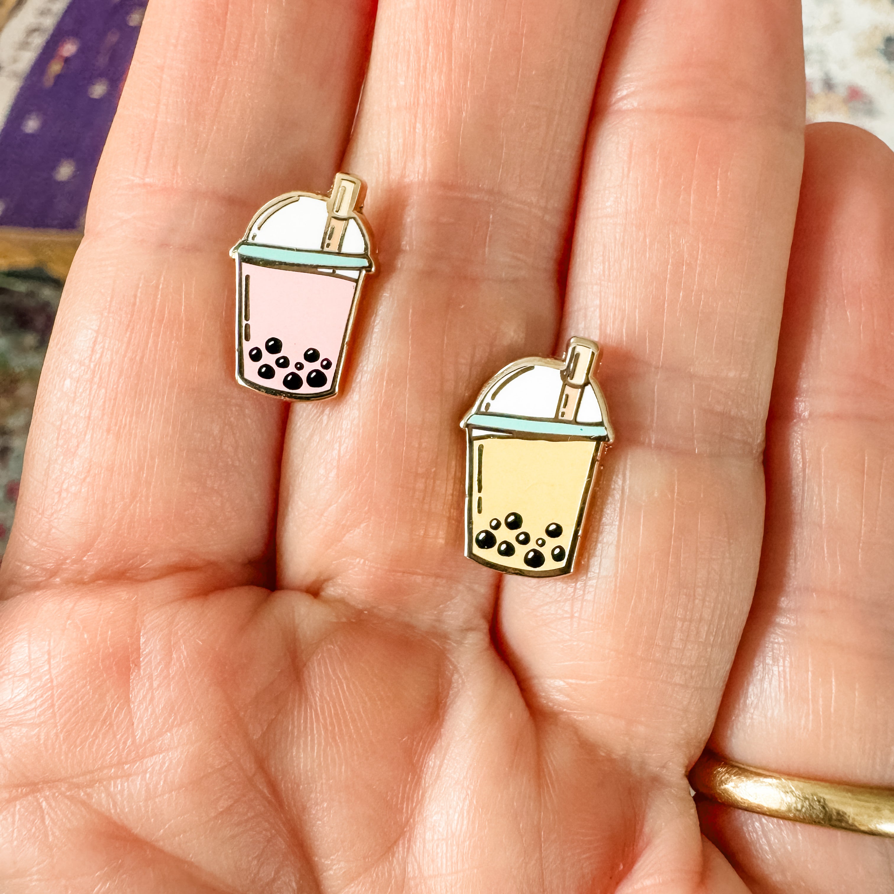 a person holding a pair of earrings in their hand