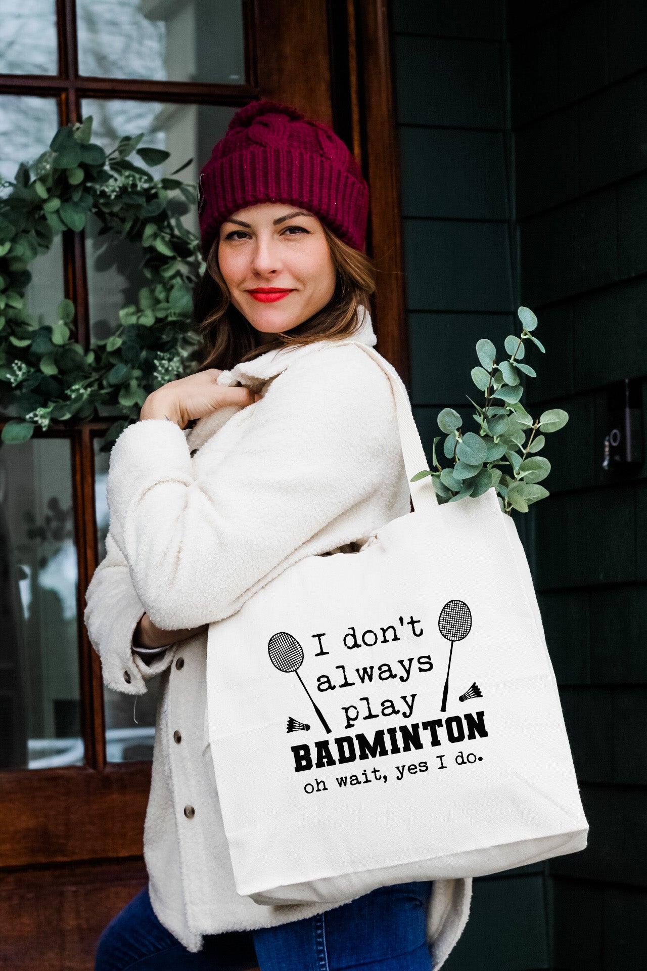 a woman carrying a bag that says i don't always play badminton on what