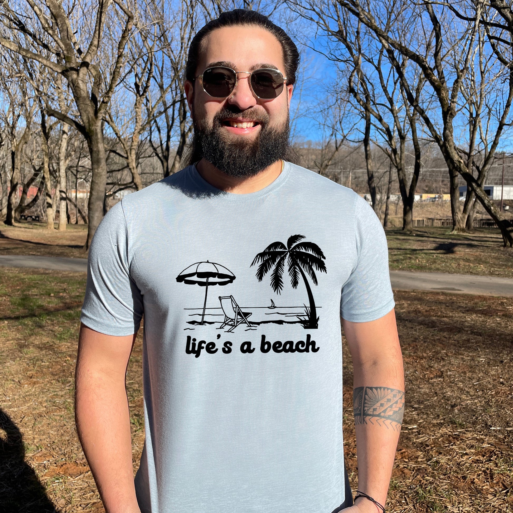 a man with a beard wearing a life's a beach t - shirt