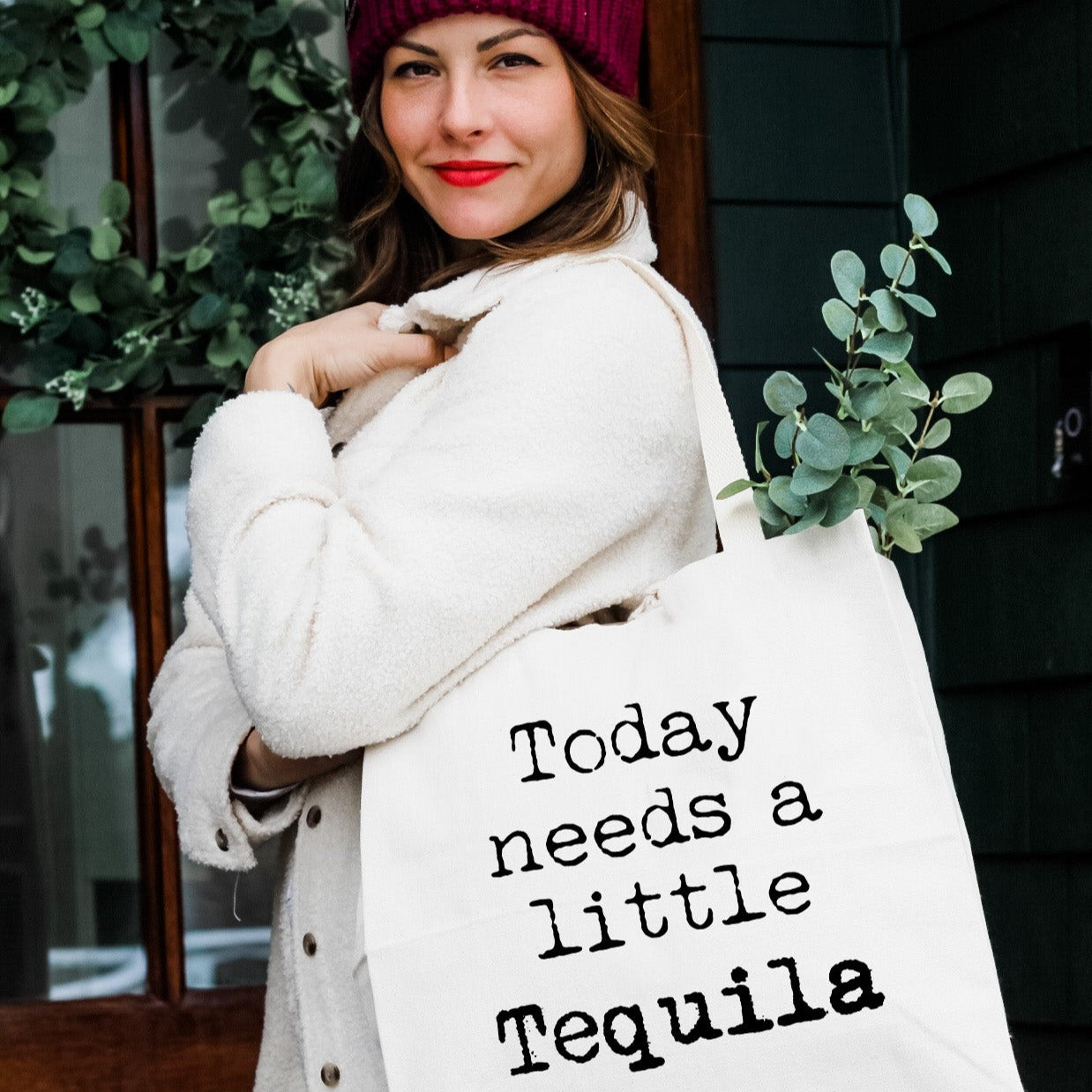 a woman carrying a bag that says today needs a little tequila