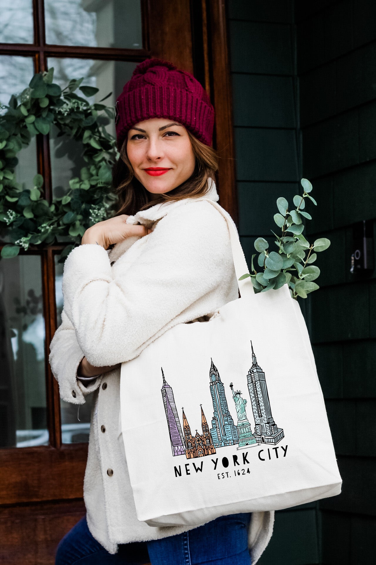 a woman carrying a new york city shopping bag