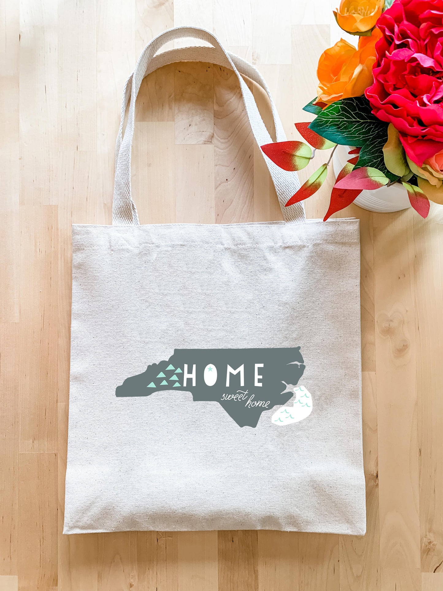 a white tote bag with the word home on it