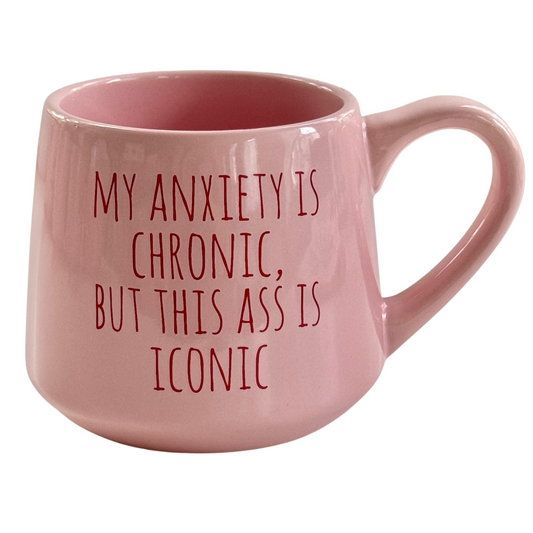 a pink coffee mug with the words, my anxiety is chronic but this ass is