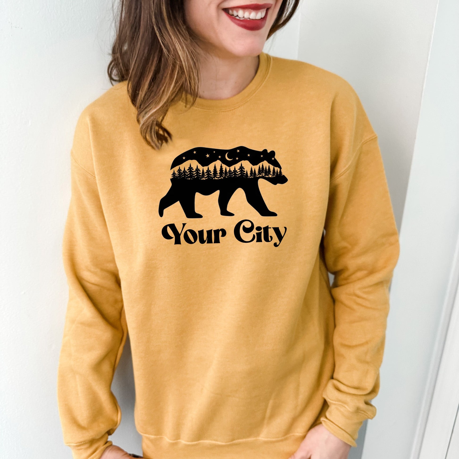 a woman wearing a sweatshirt with a bear on it