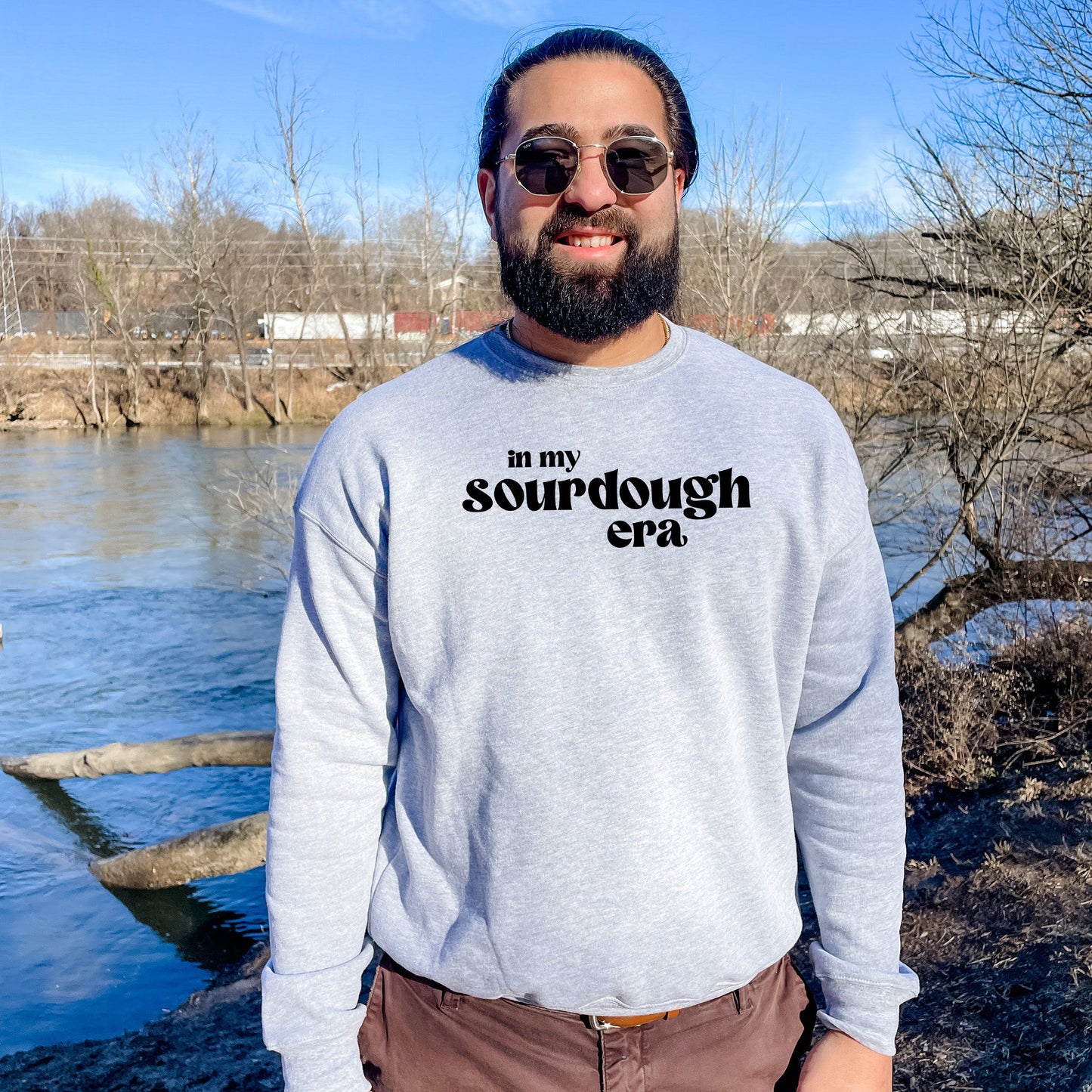 a man standing in front of a body of water