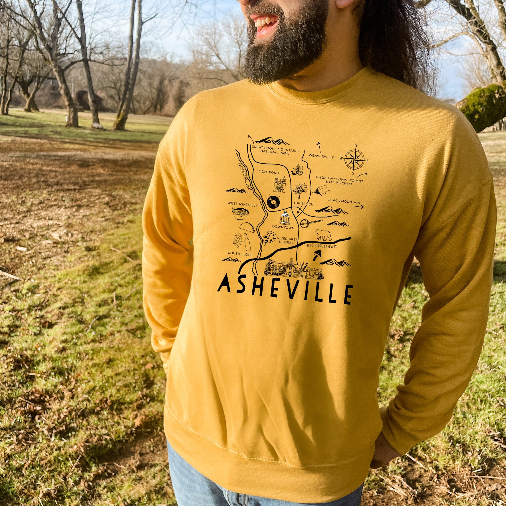 a man with a beard wearing a yellow sweatshirt