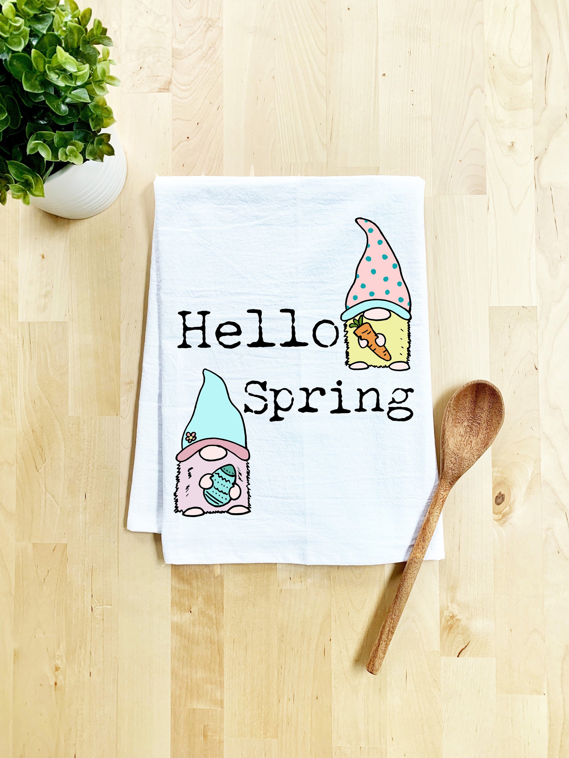 a tea towel that says hello spring next to a potted plant