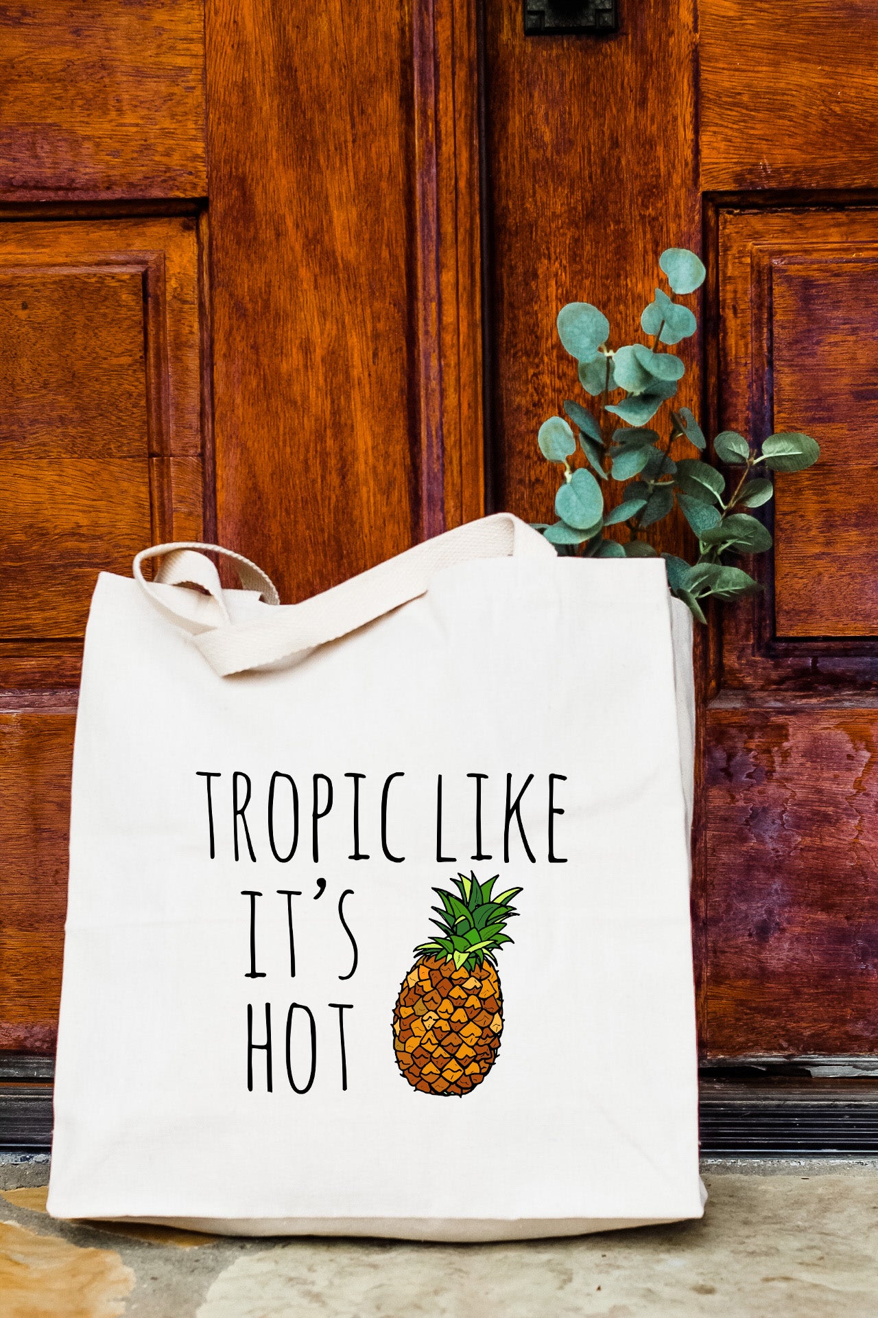 a white tote bag with a pineapple printed on it