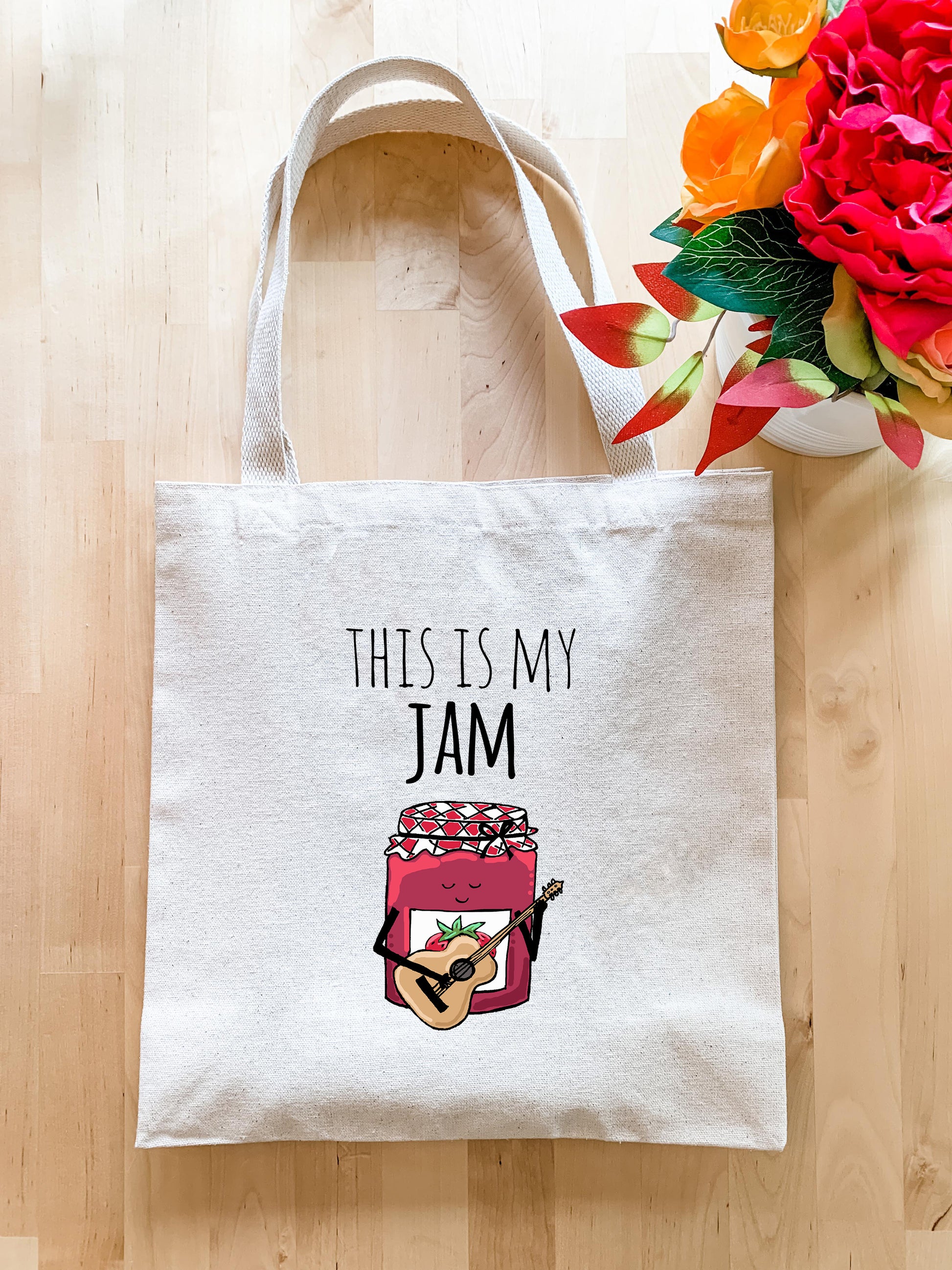 this is my jam tote bag next to a bouquet of flowers