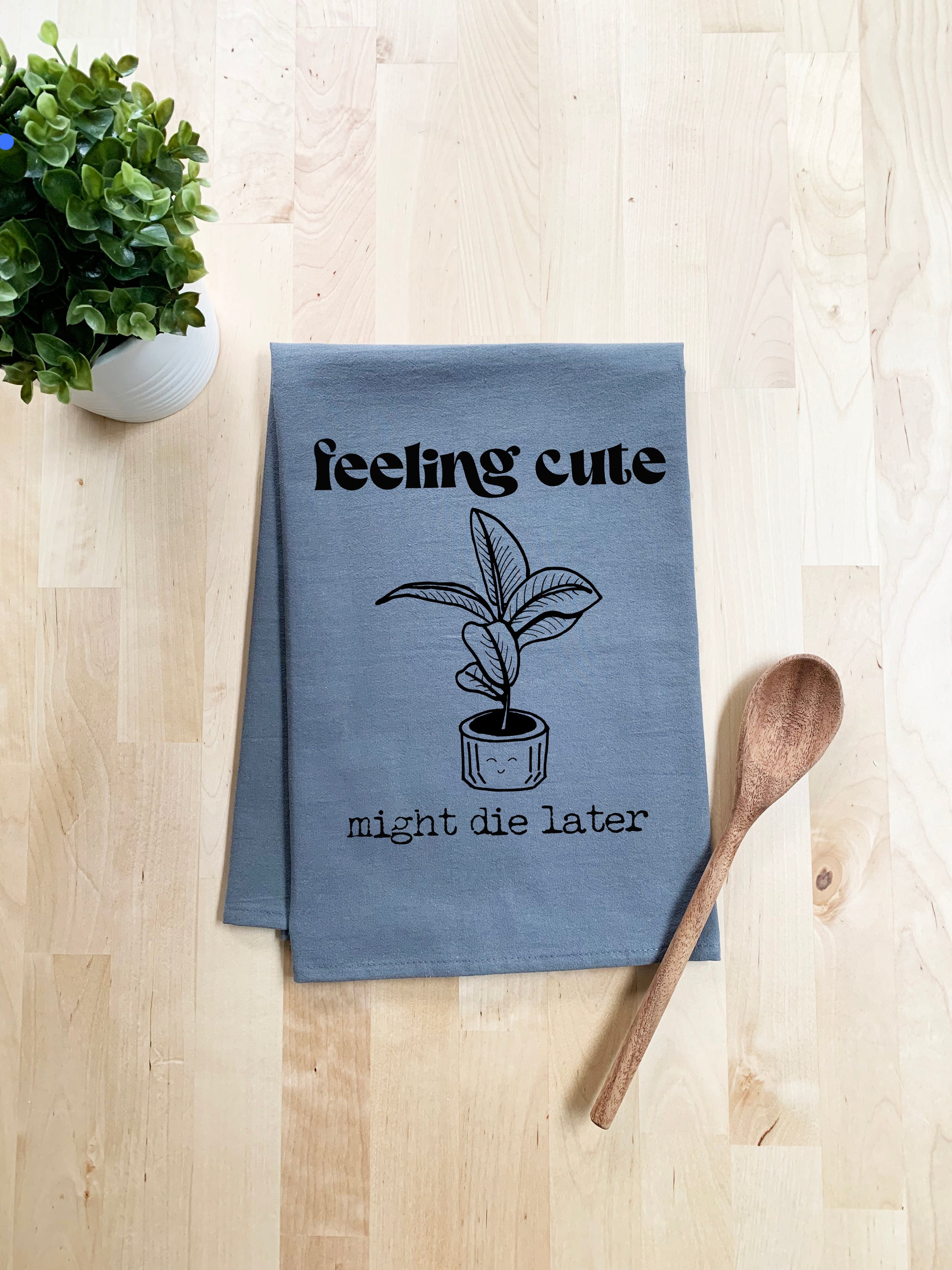 a tea towel with a potted plant next to it