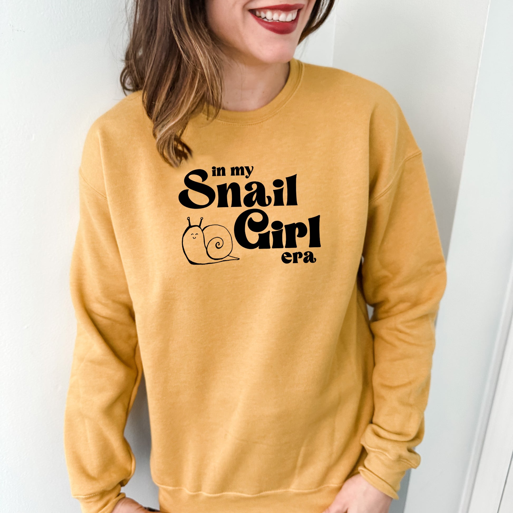 a woman wearing a sweatshirt that says in my small girl