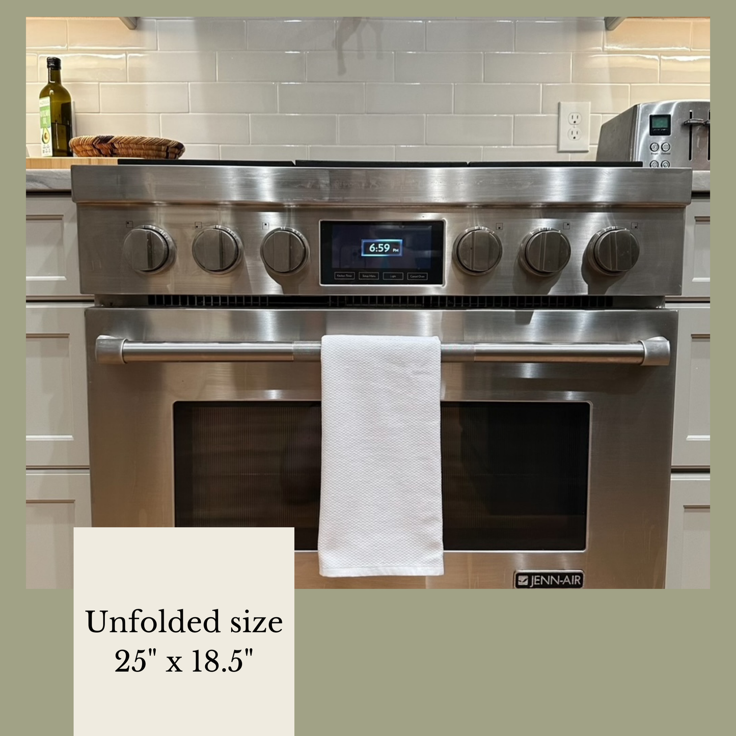 a stainless steel oven with a towel hanging on it