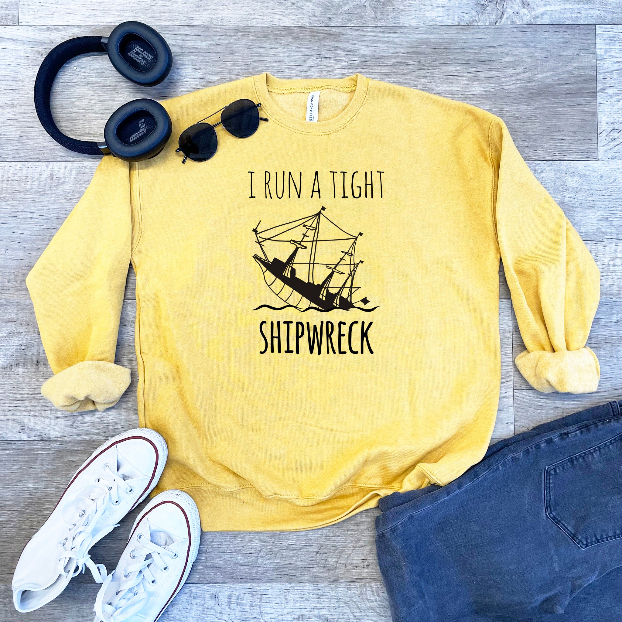 a yellow sweatshirt with a shipwreck on it