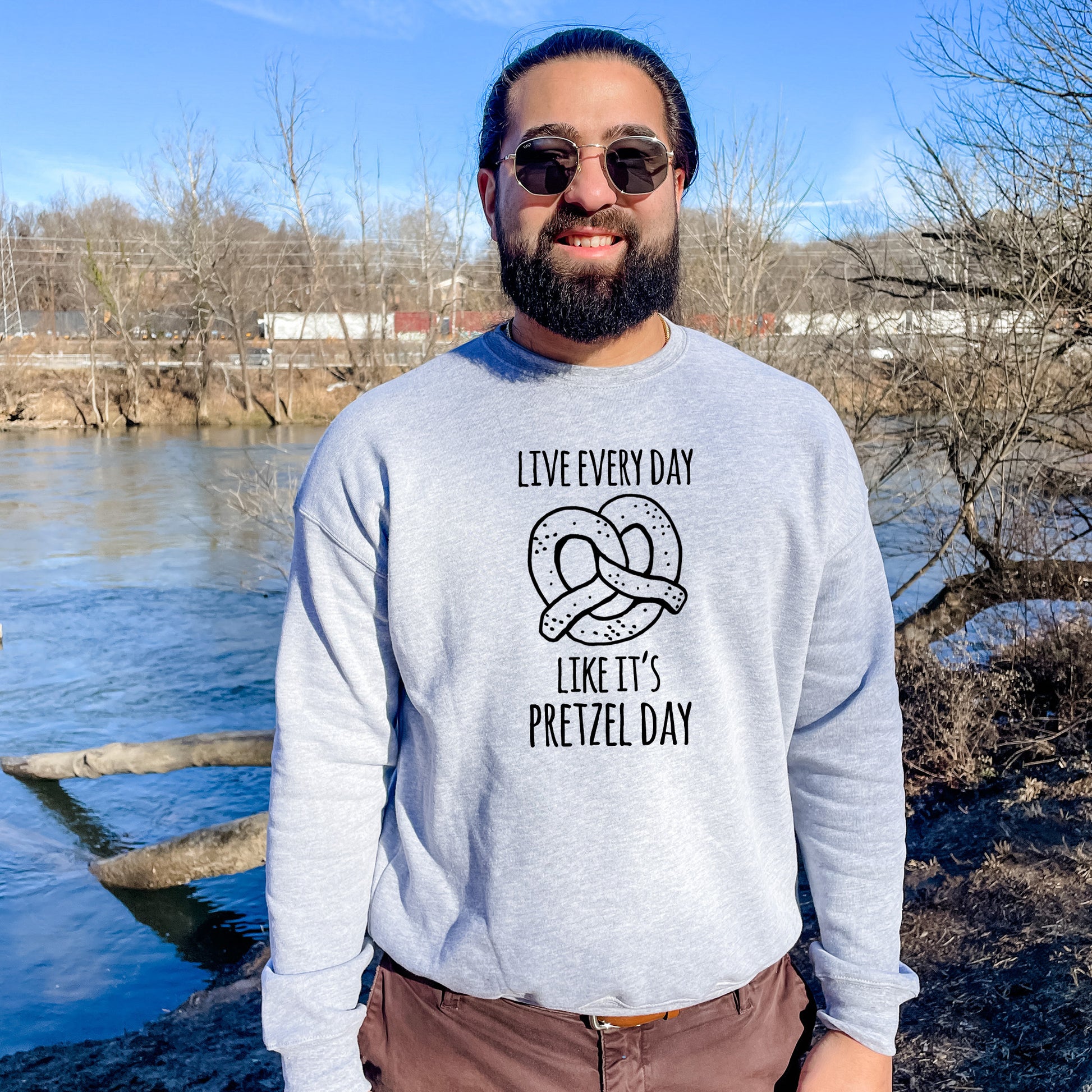 a man with a beard wearing a sweater that says live every day like it '