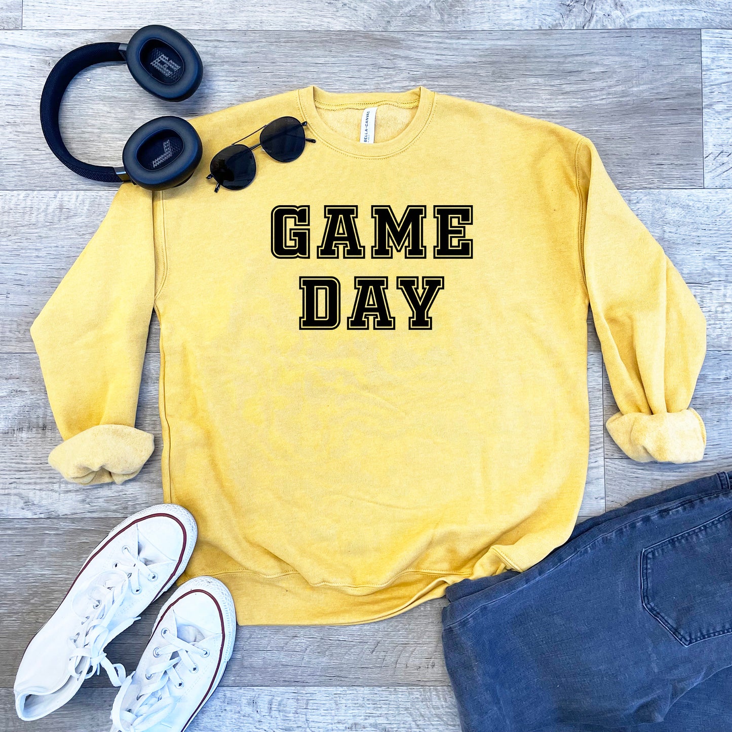 a sweatshirt that says game day next to headphones