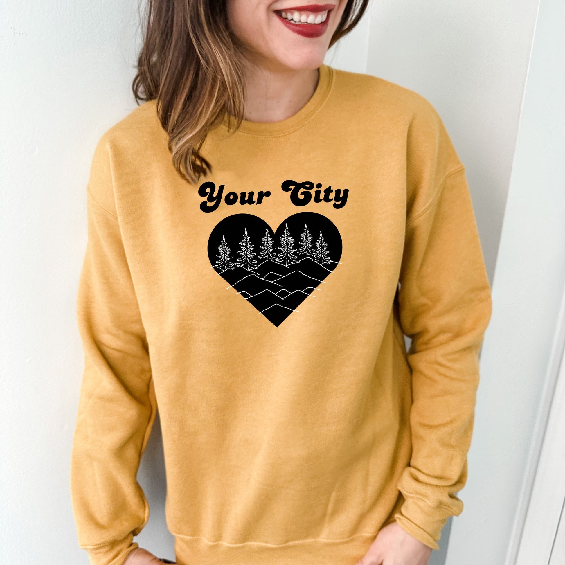 a woman wearing a yellow sweatshirt with a heart on it