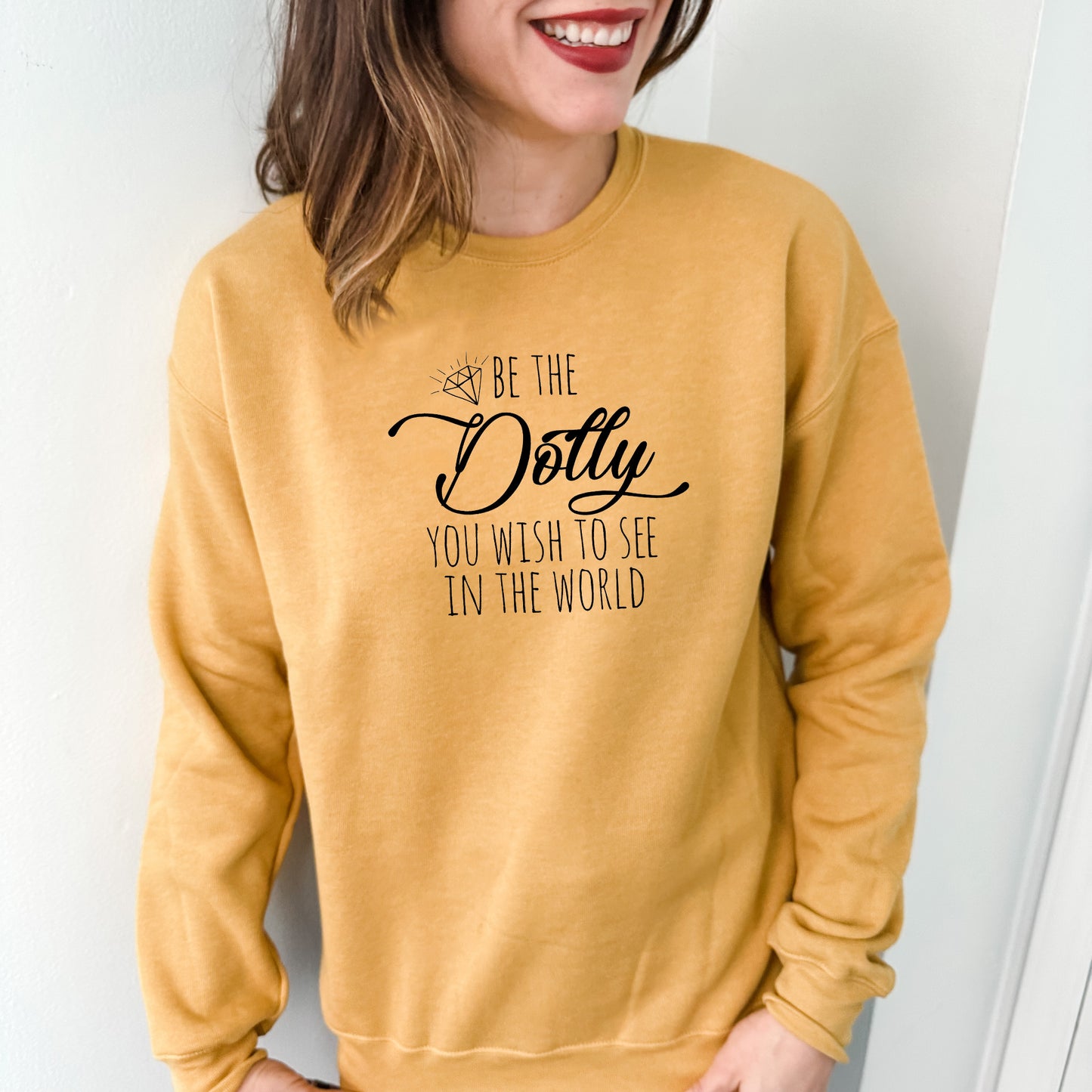 a woman wearing a sweatshirt that says be the doty you wish to see in