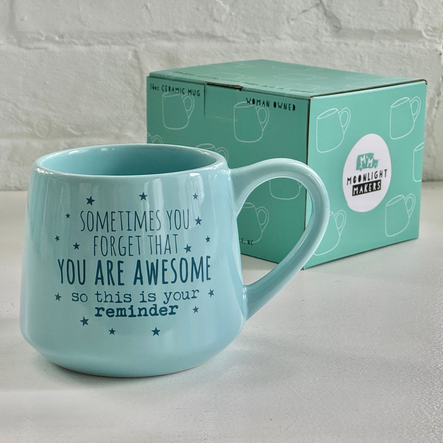 a blue coffee mug sitting next to a box