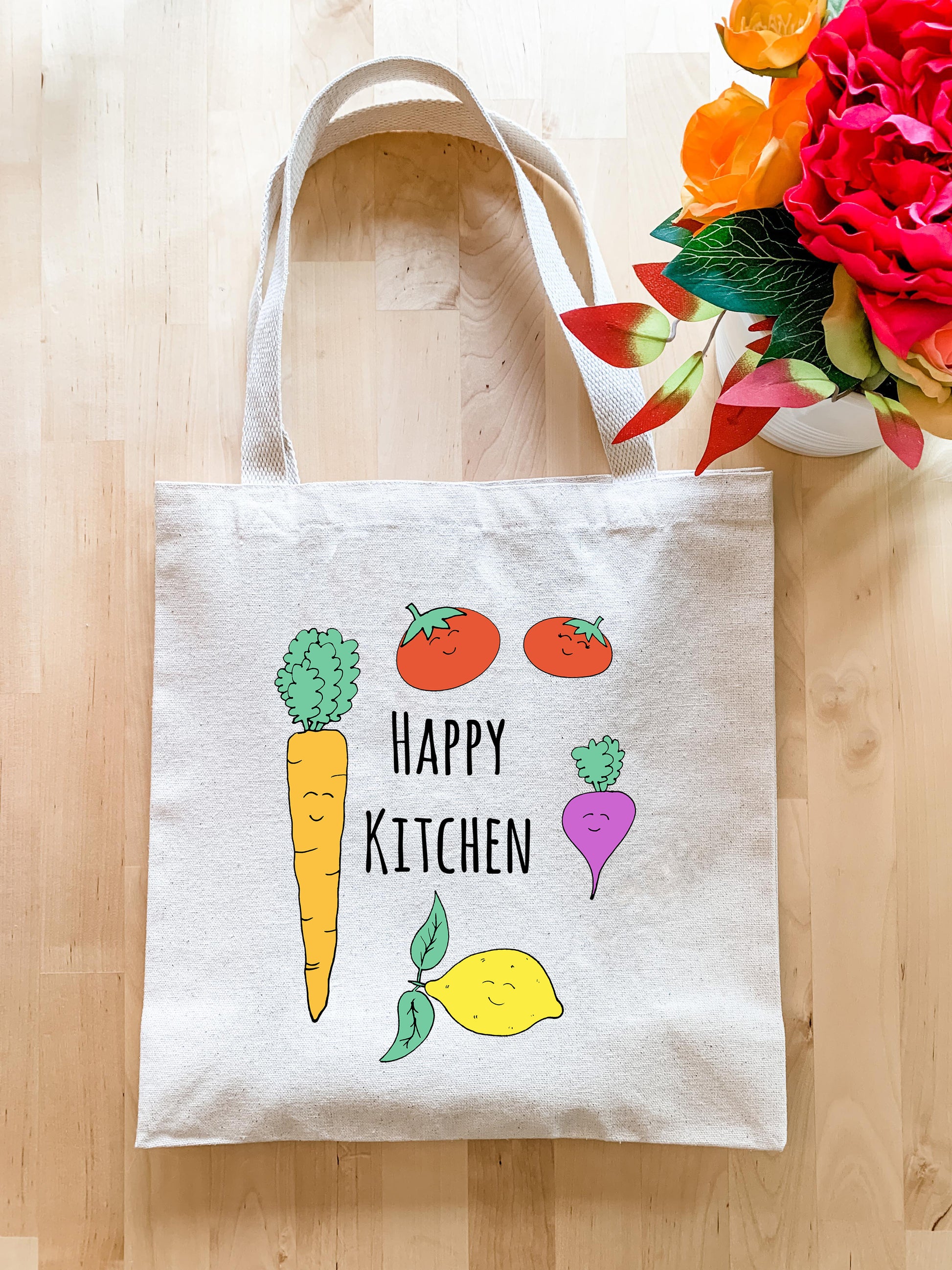 a happy kitchen bag next to a bouquet of flowers
