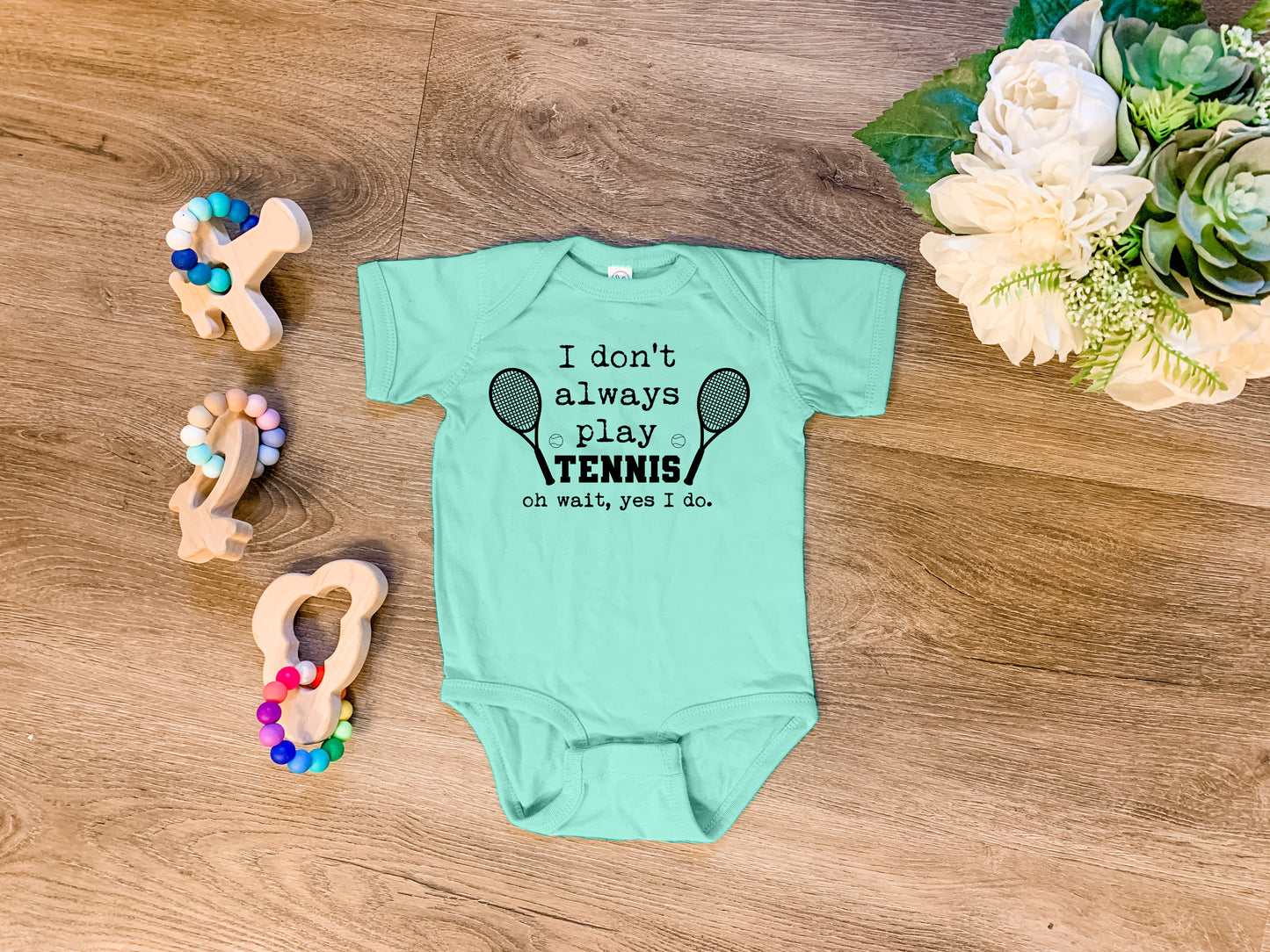 a baby bodysuit that says i don't always play tennis