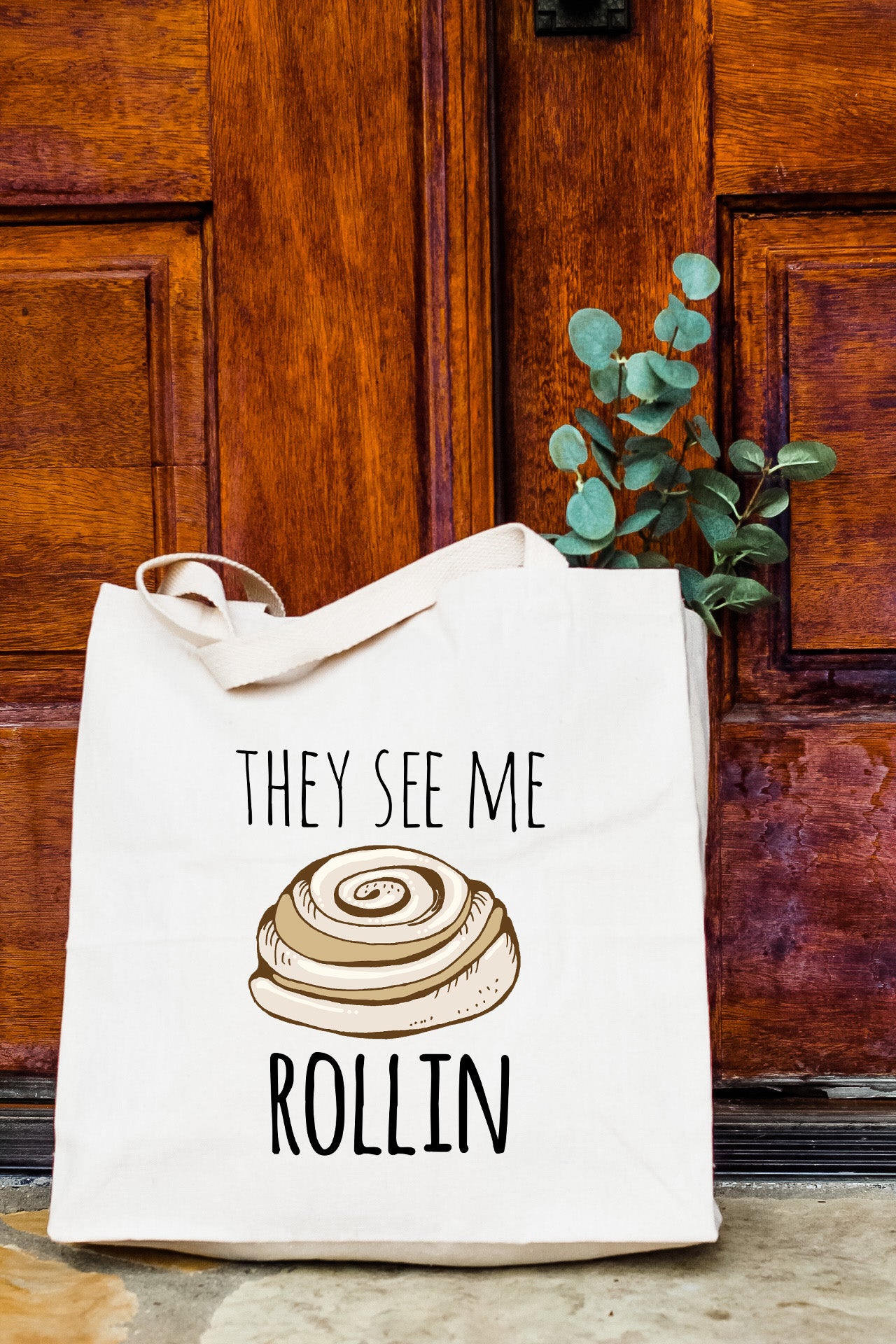 a tote bag with a picture of a roll on it