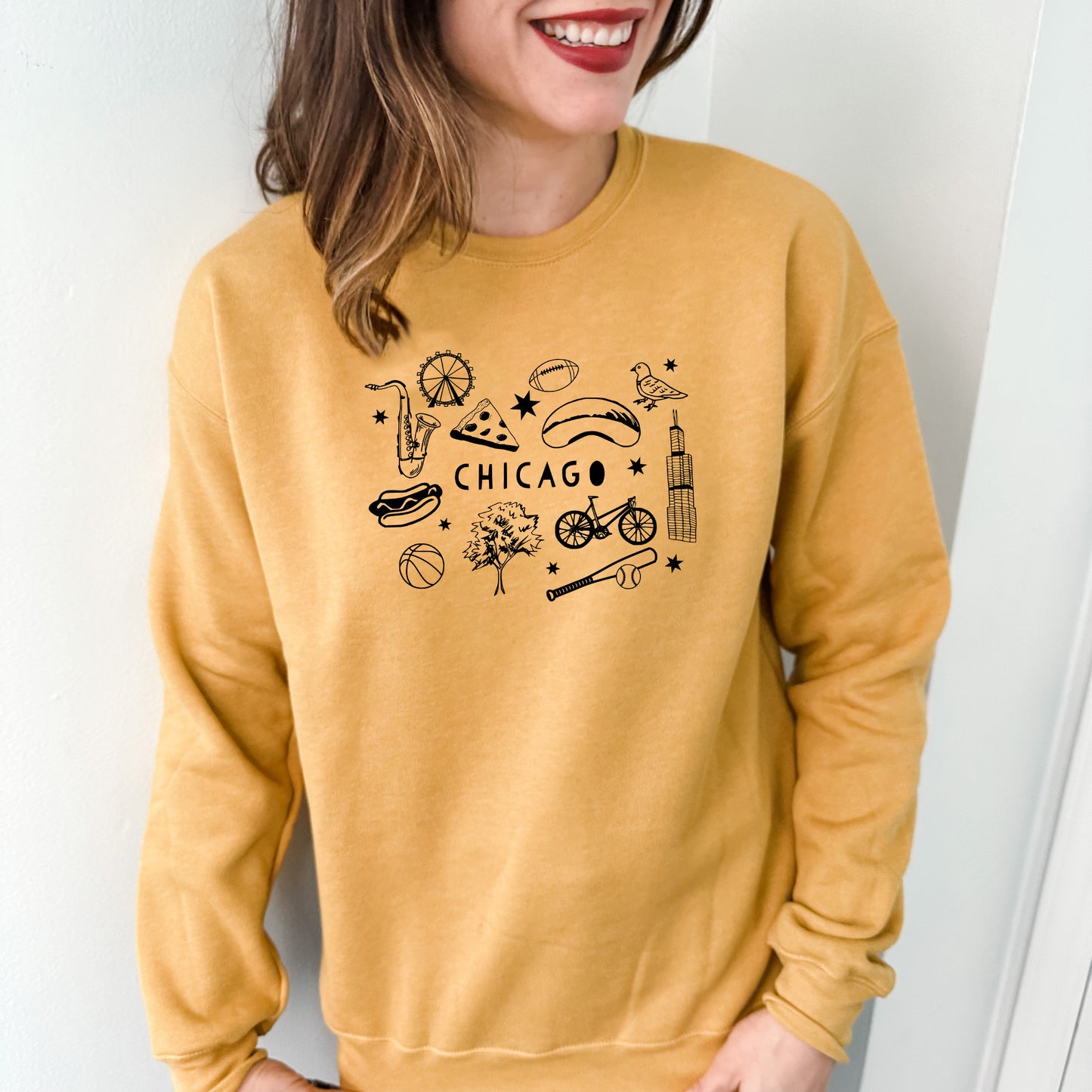 a smiling woman wearing a chicago sweatshirt