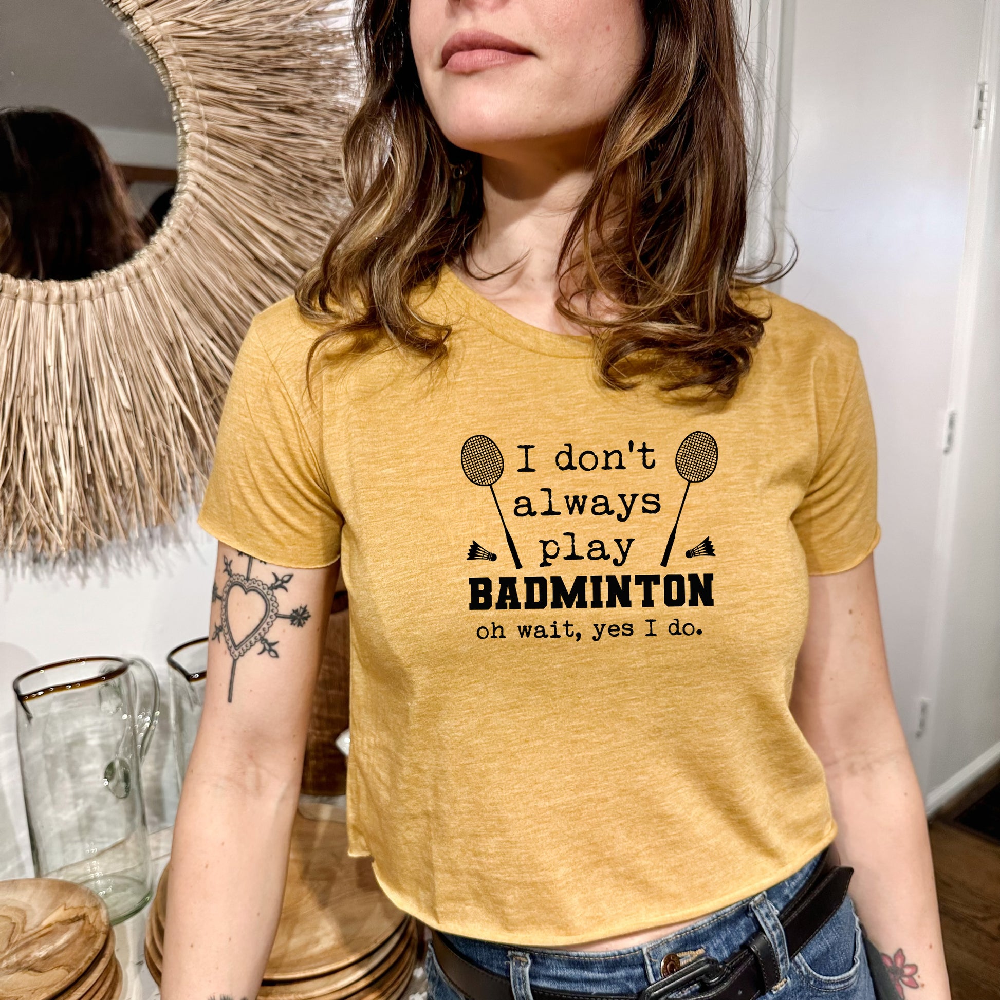 a woman wearing a t - shirt that says i don't always play badminton