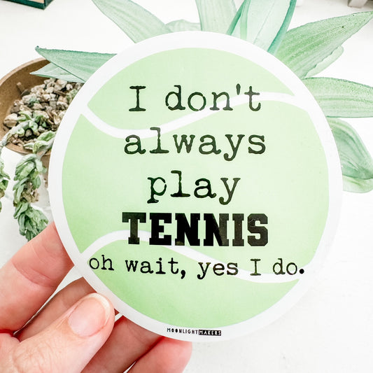 a hand holding a sticker that says i don't always play tennis on