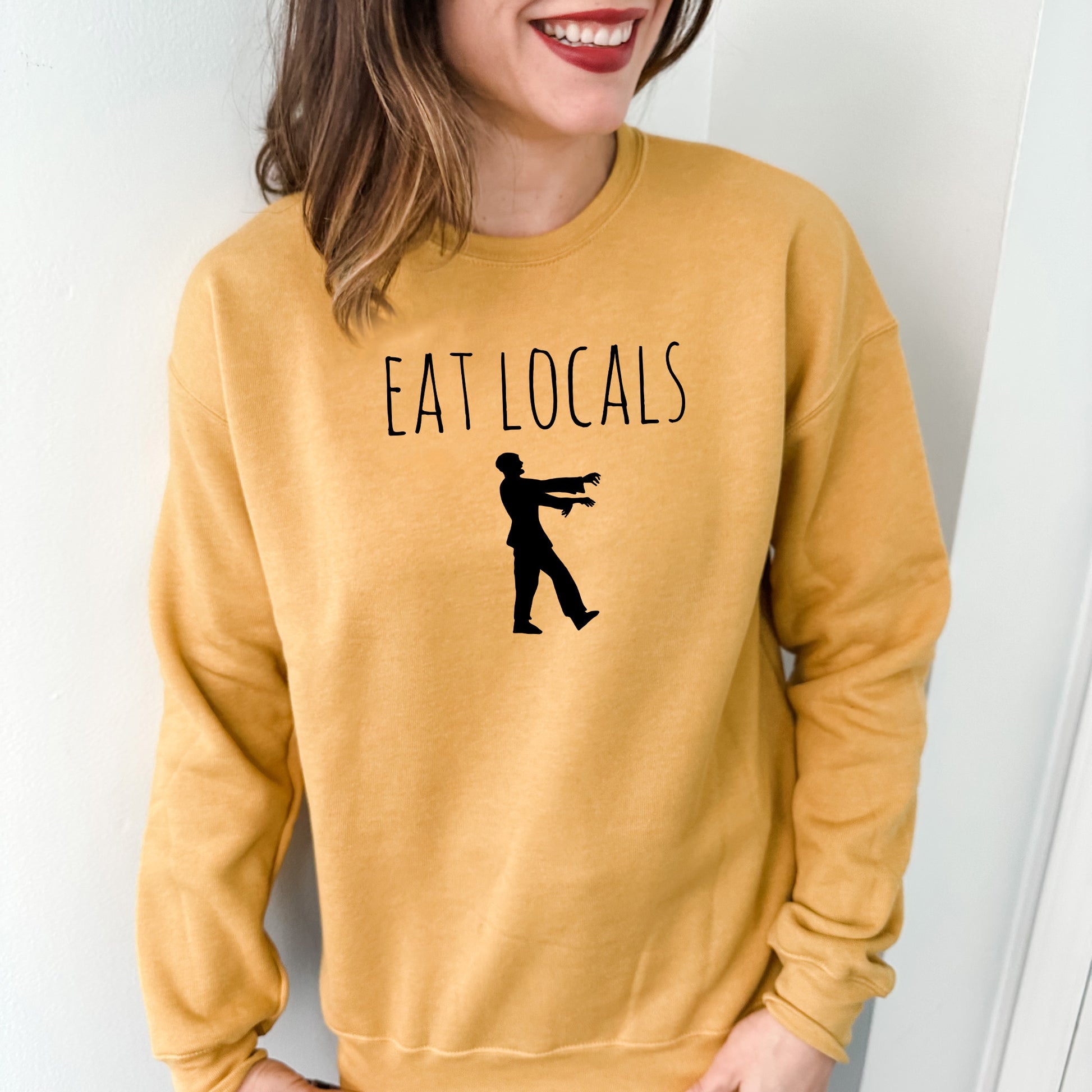 a woman wearing a sweatshirt that says eat locals