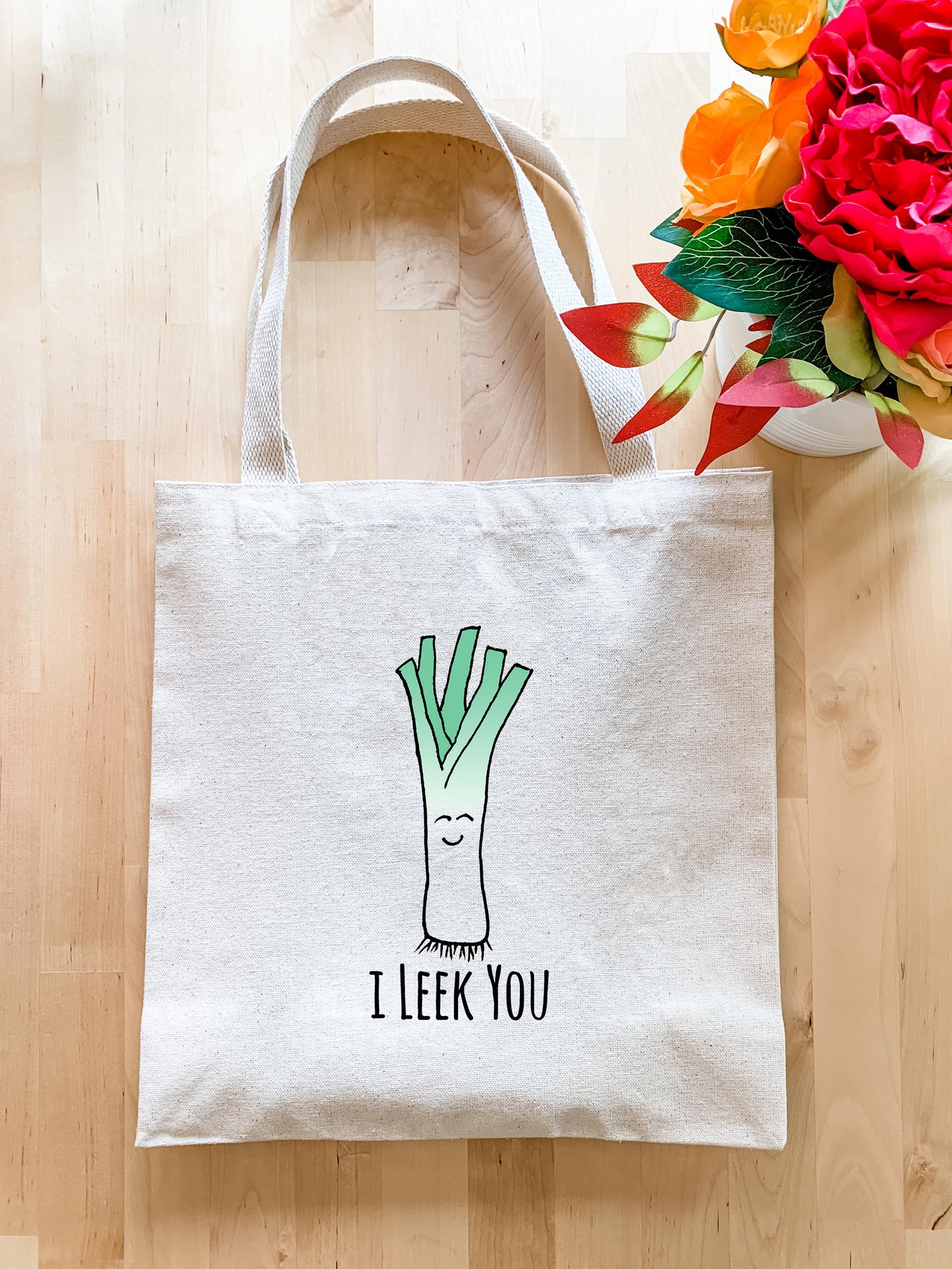 a white tote bag with a picture of a leek on it