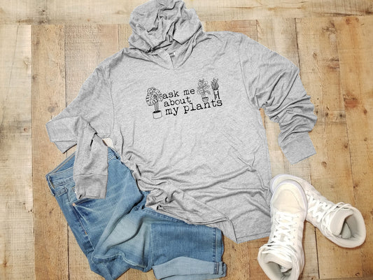 a gray hoodie with trees on it and a pair of jeans