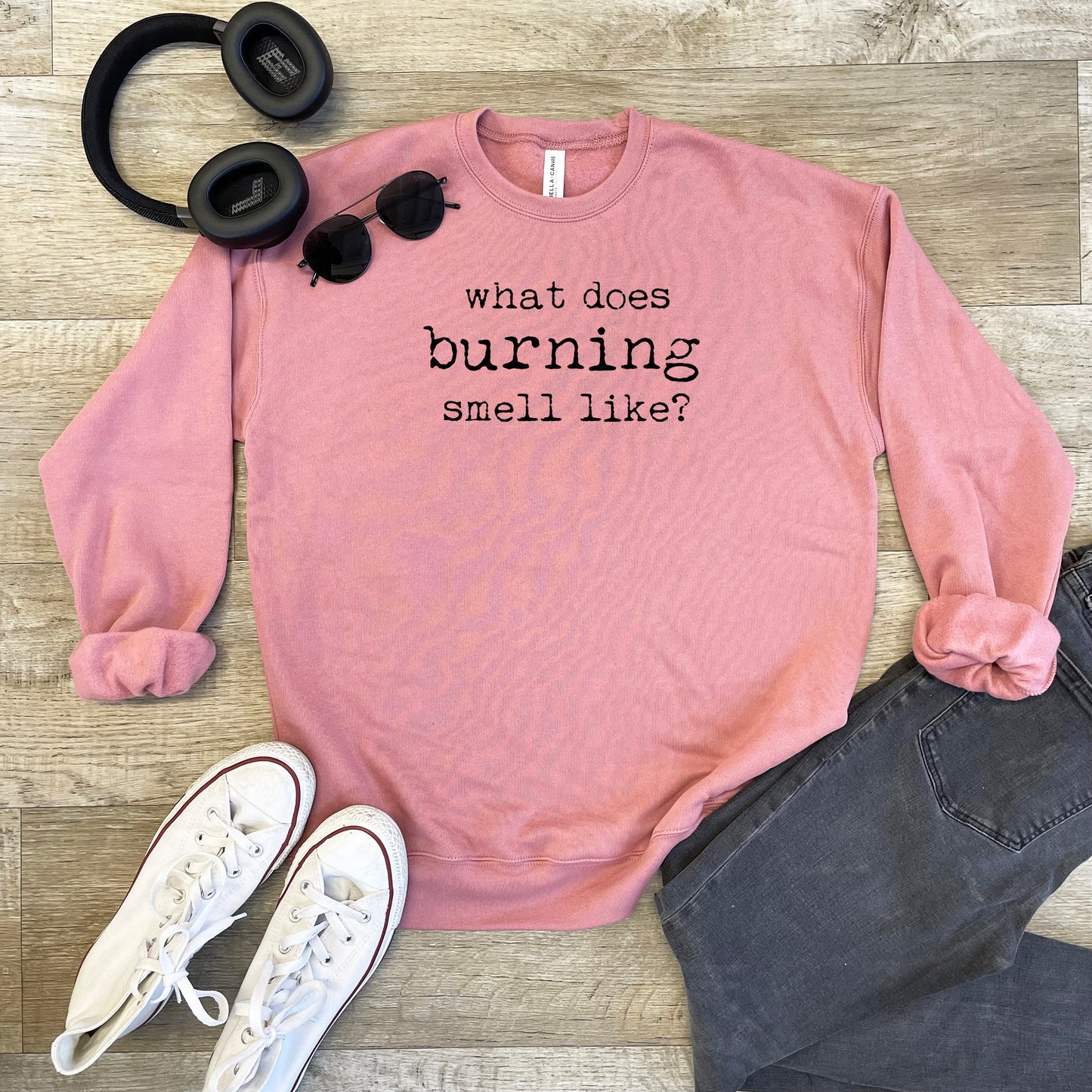 a pink sweatshirt that says, what does burning smell like?