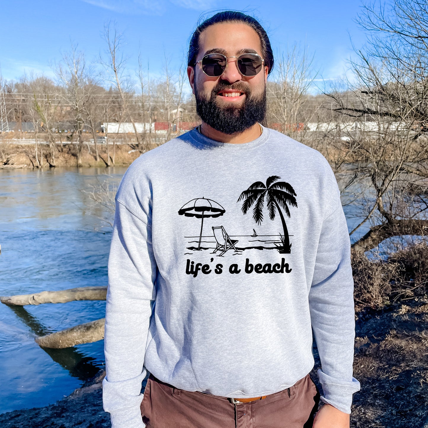 a man standing in front of a body of water