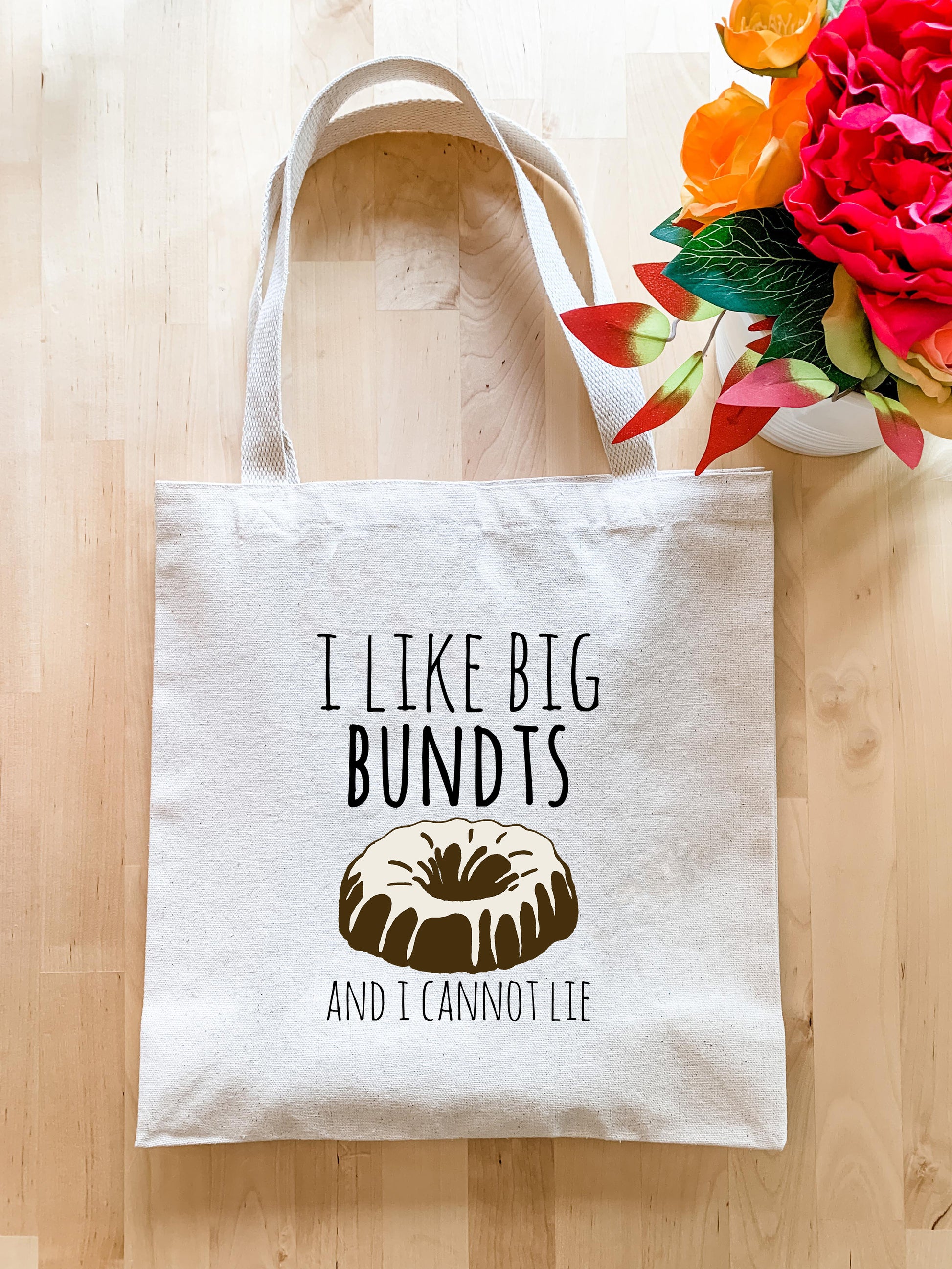 a bag with a bundt on it sitting next to a vase of flowers