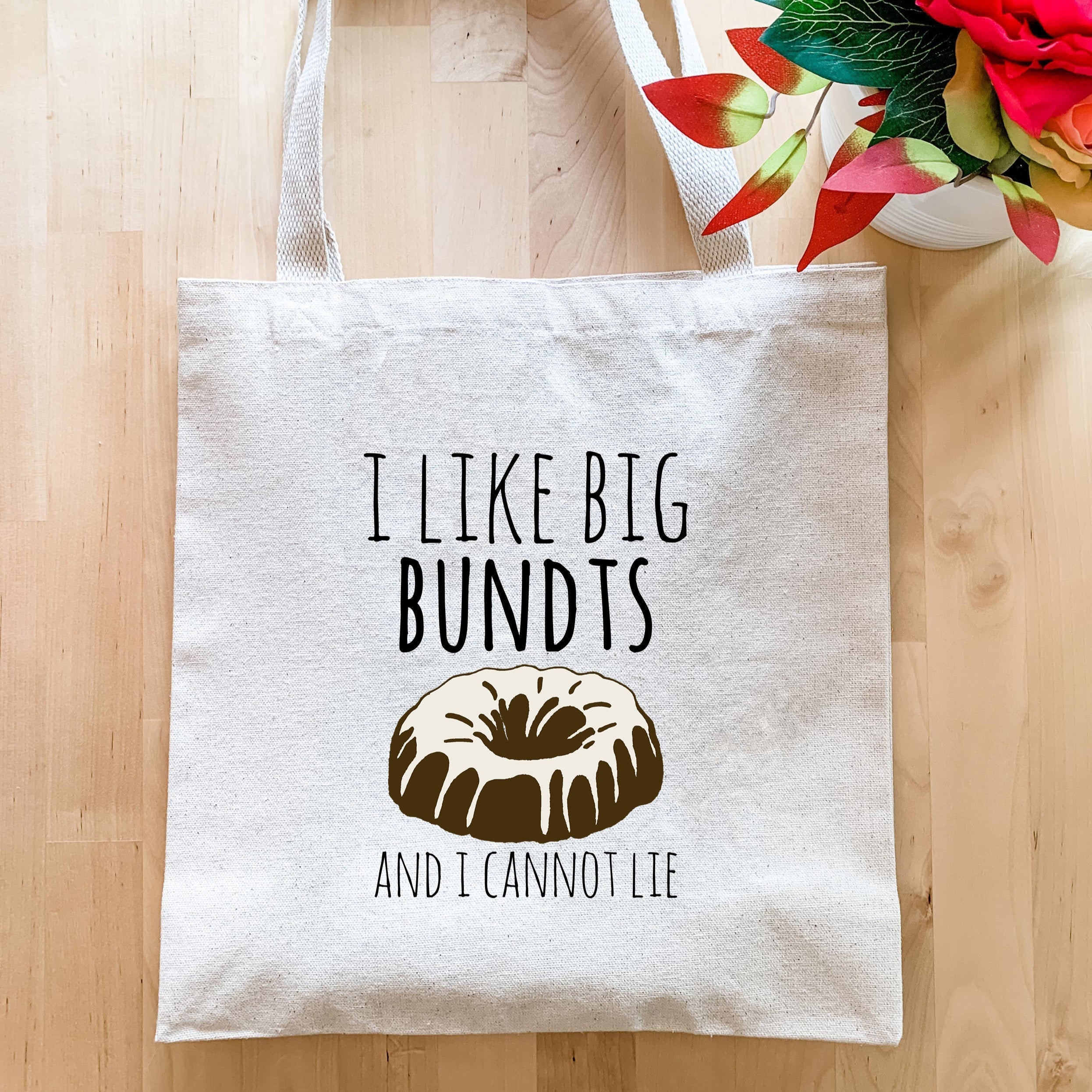 a bag with a bundt on it sitting next to a vase of flowers