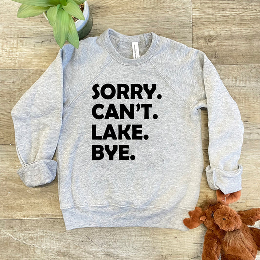 a sweater that says sorry, can't lake bye next to a teddy bear