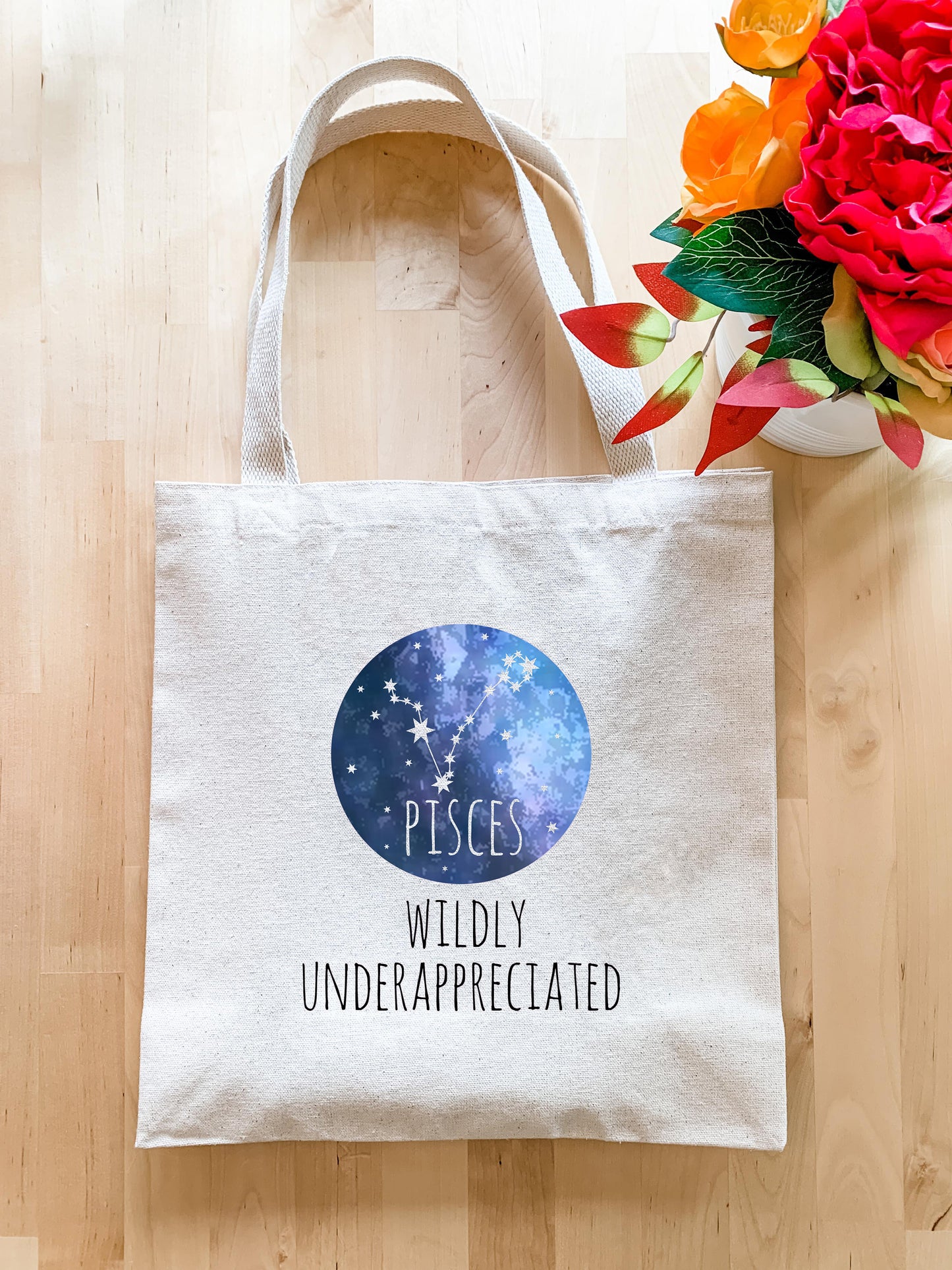 a white tote bag with a space themed design