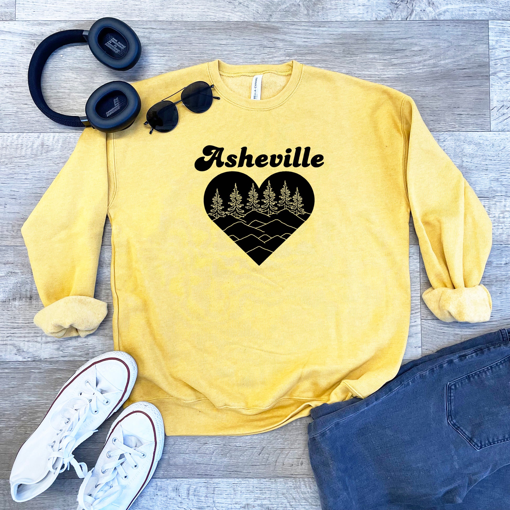 a yellow sweatshirt with a heart and trees on it