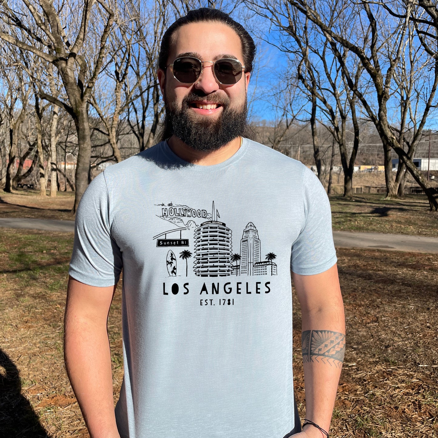 a man with a beard wearing a los angeles t - shirt