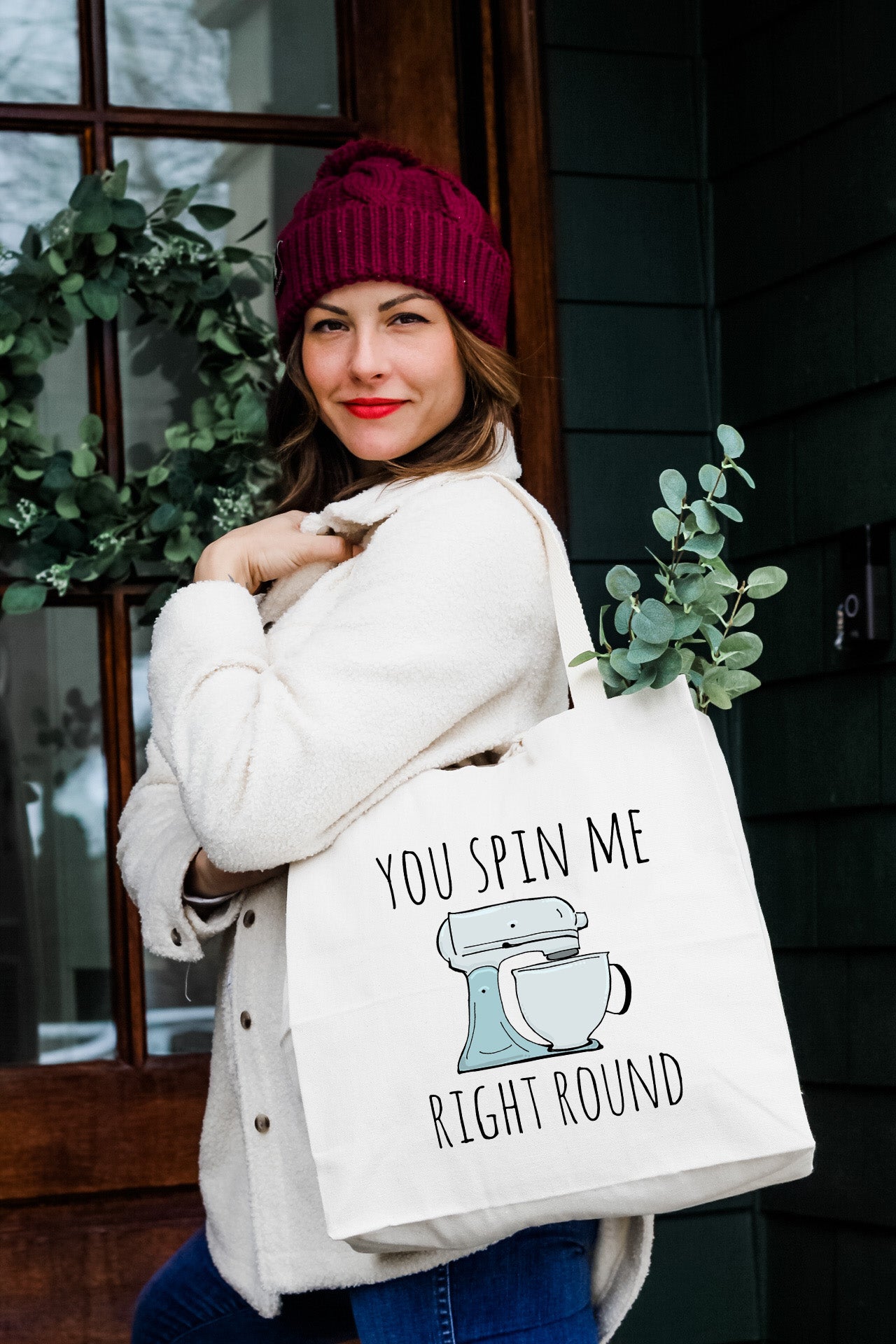 a woman holding a bag that says you spin me right round