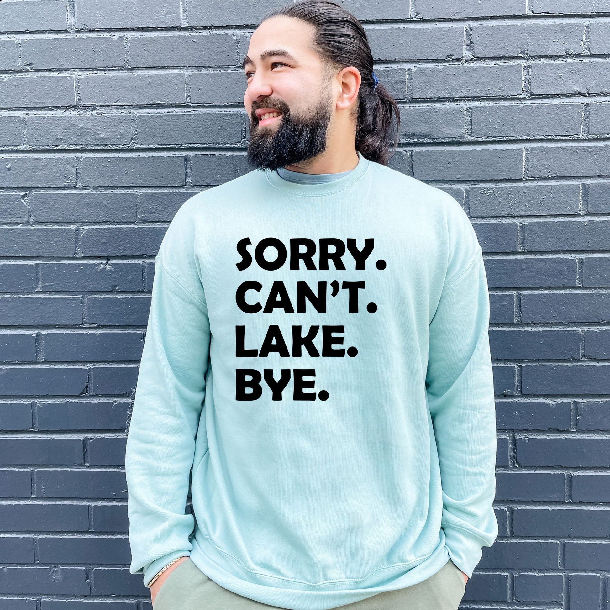 a man with a beard wearing a sweatshirt that says sorry can't lake bye