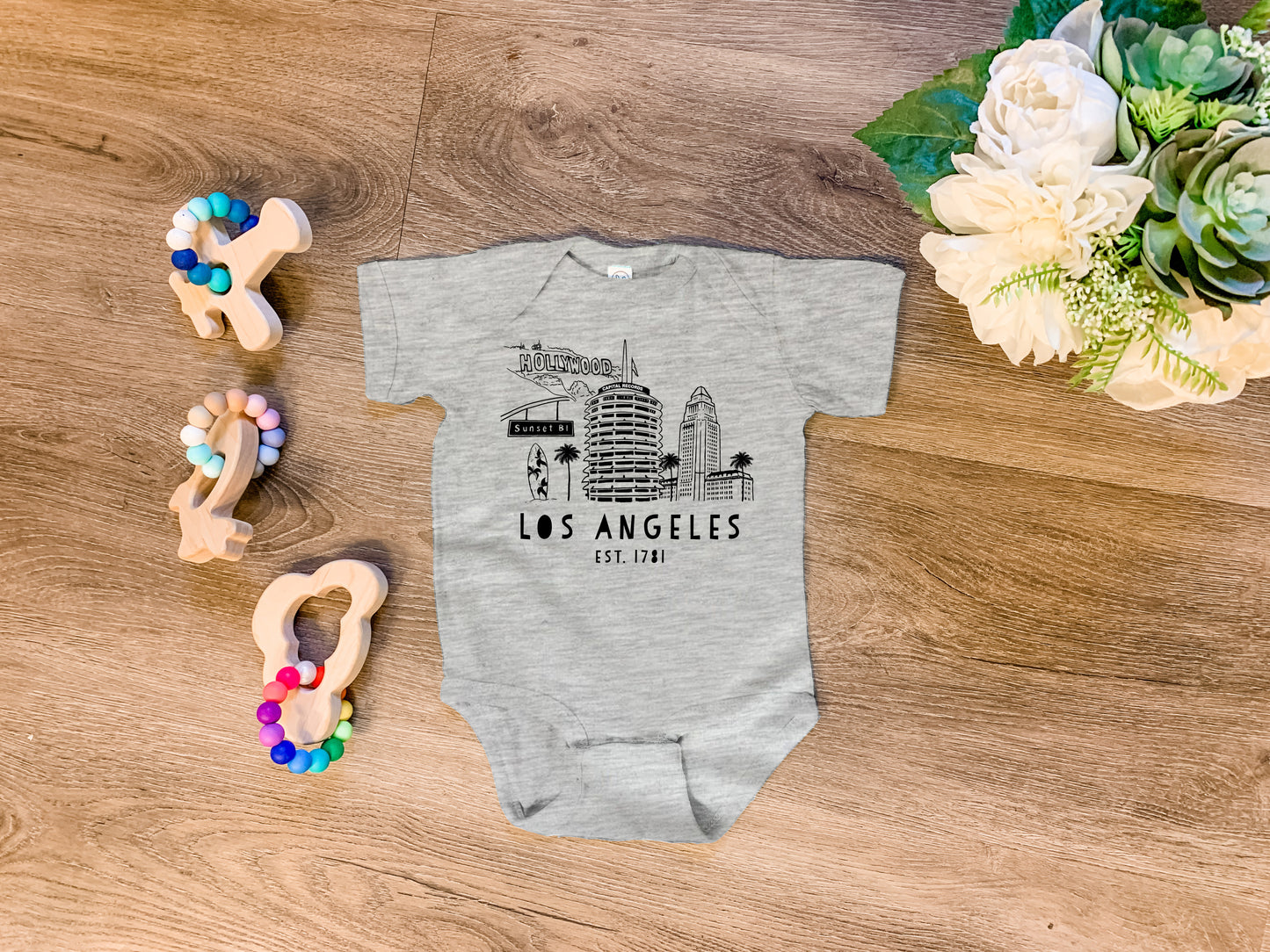 a baby bodysuit with the los angeles skyline on it