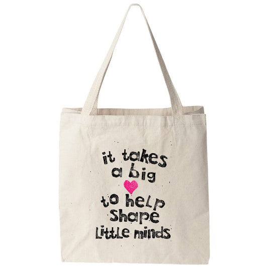 a tote bag that says it takes a big to help shape little minds