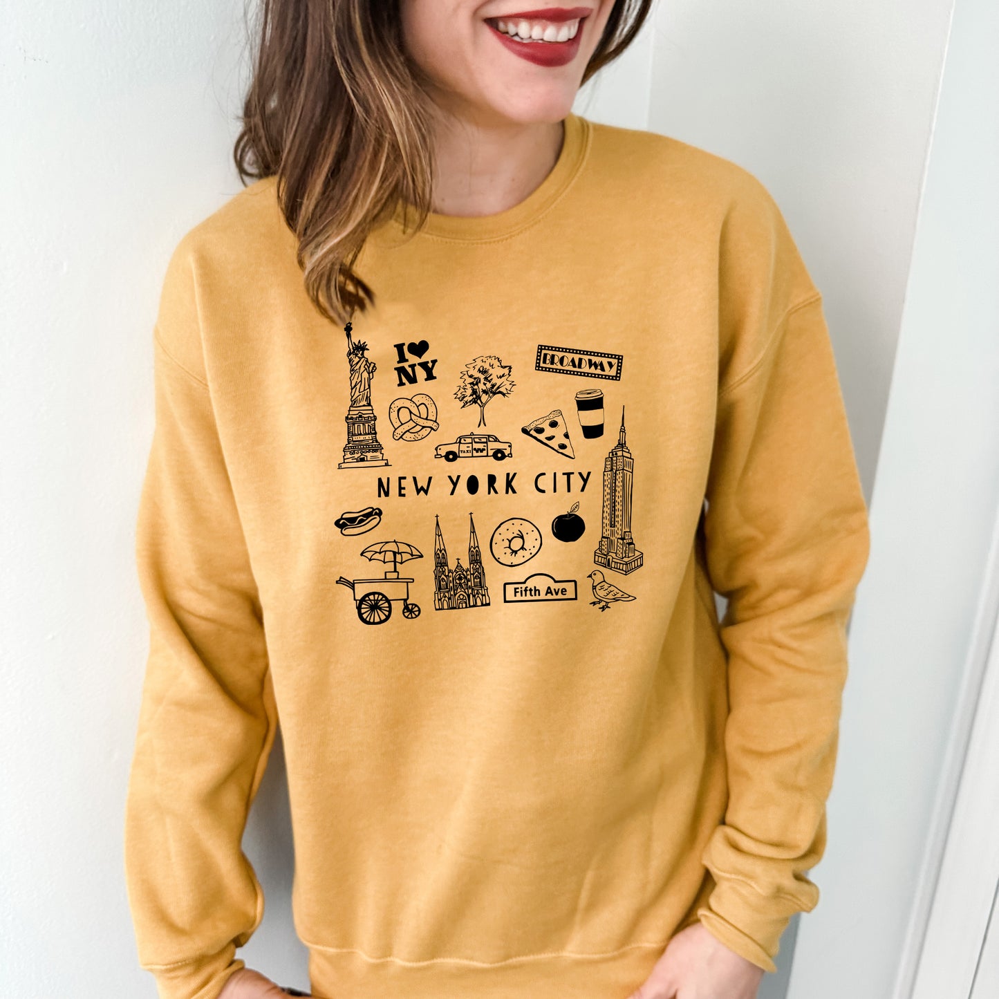 a woman wearing a new york city sweatshirt