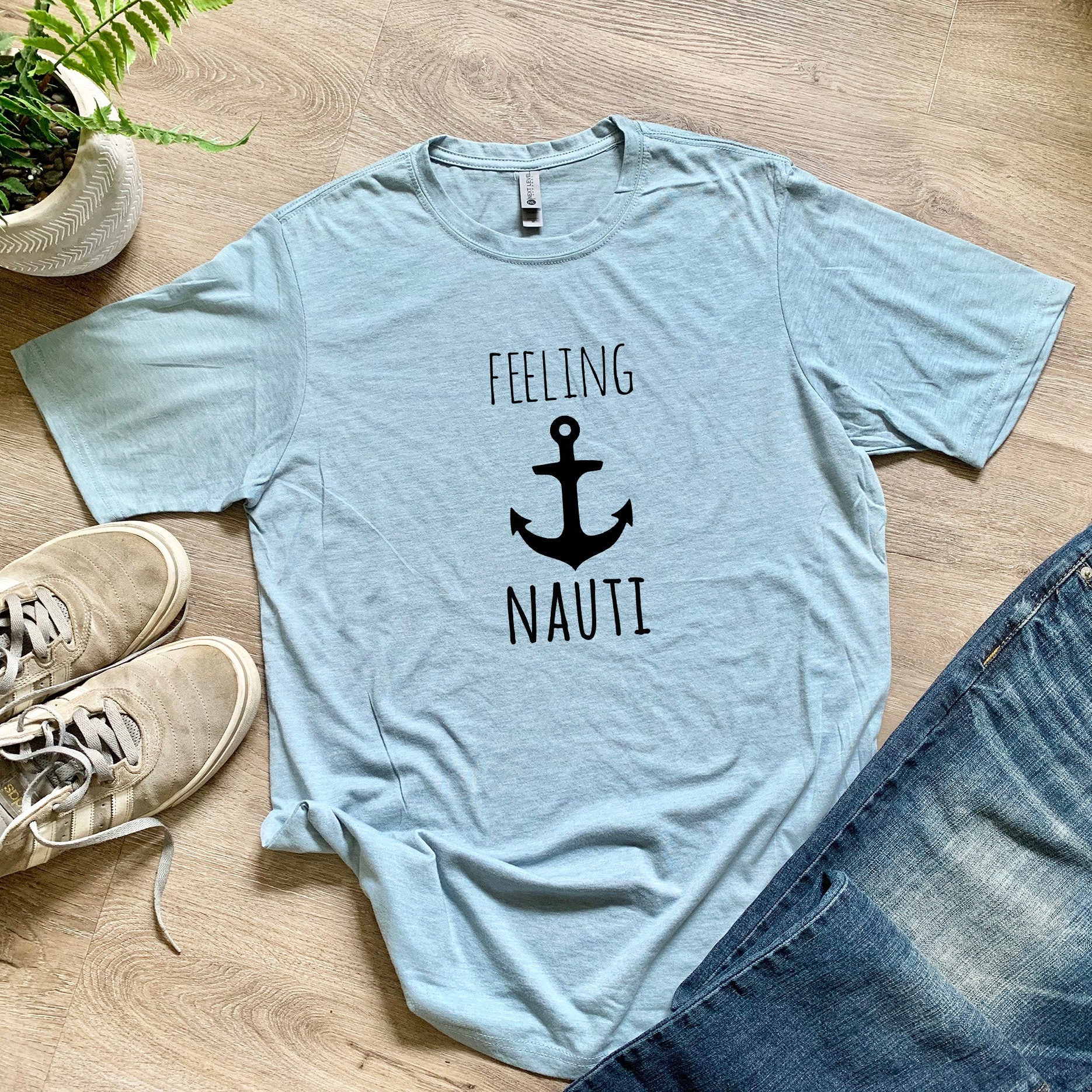 a t - shirt that says feeling nautit next to a pair of jeans