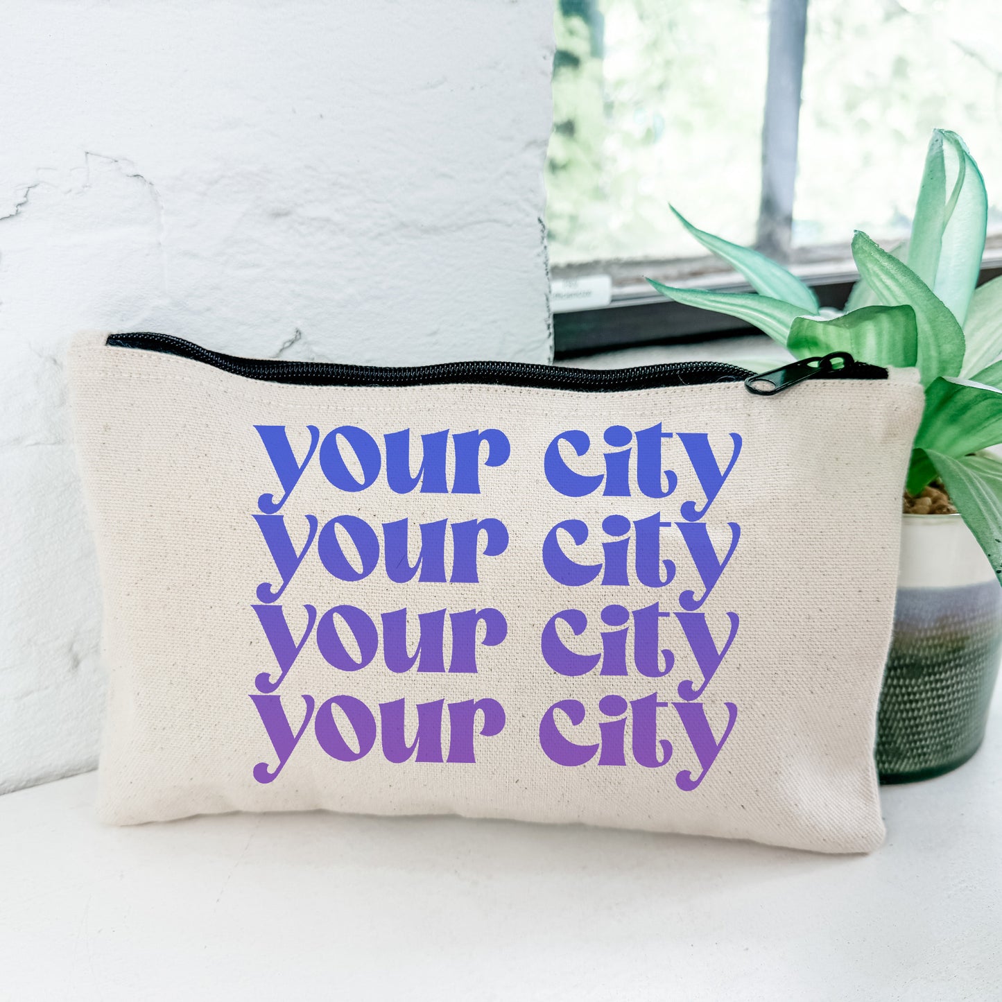 a white and purple pouch with the words your city your city on it