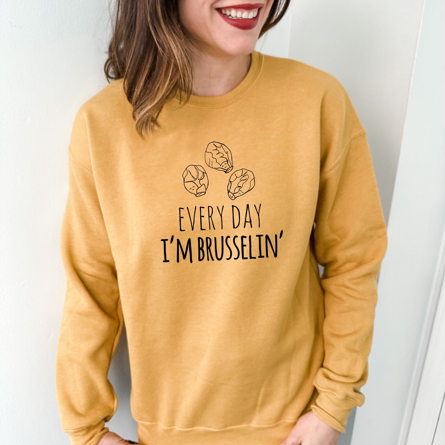 a woman wearing a sweatshirt that says every day i'm brussels